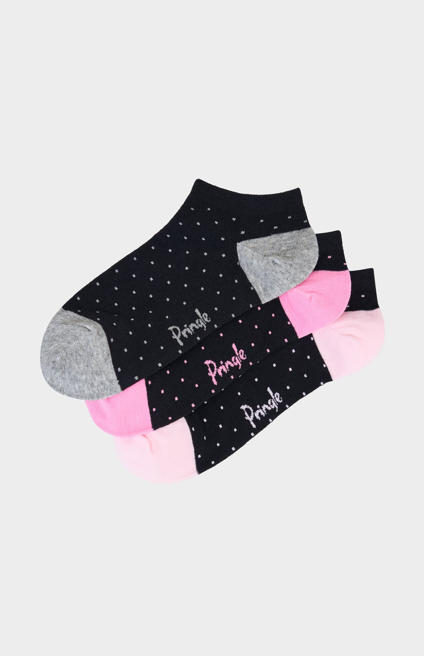 Set of black ankle socks with pink and gray polka dots on a light gray background