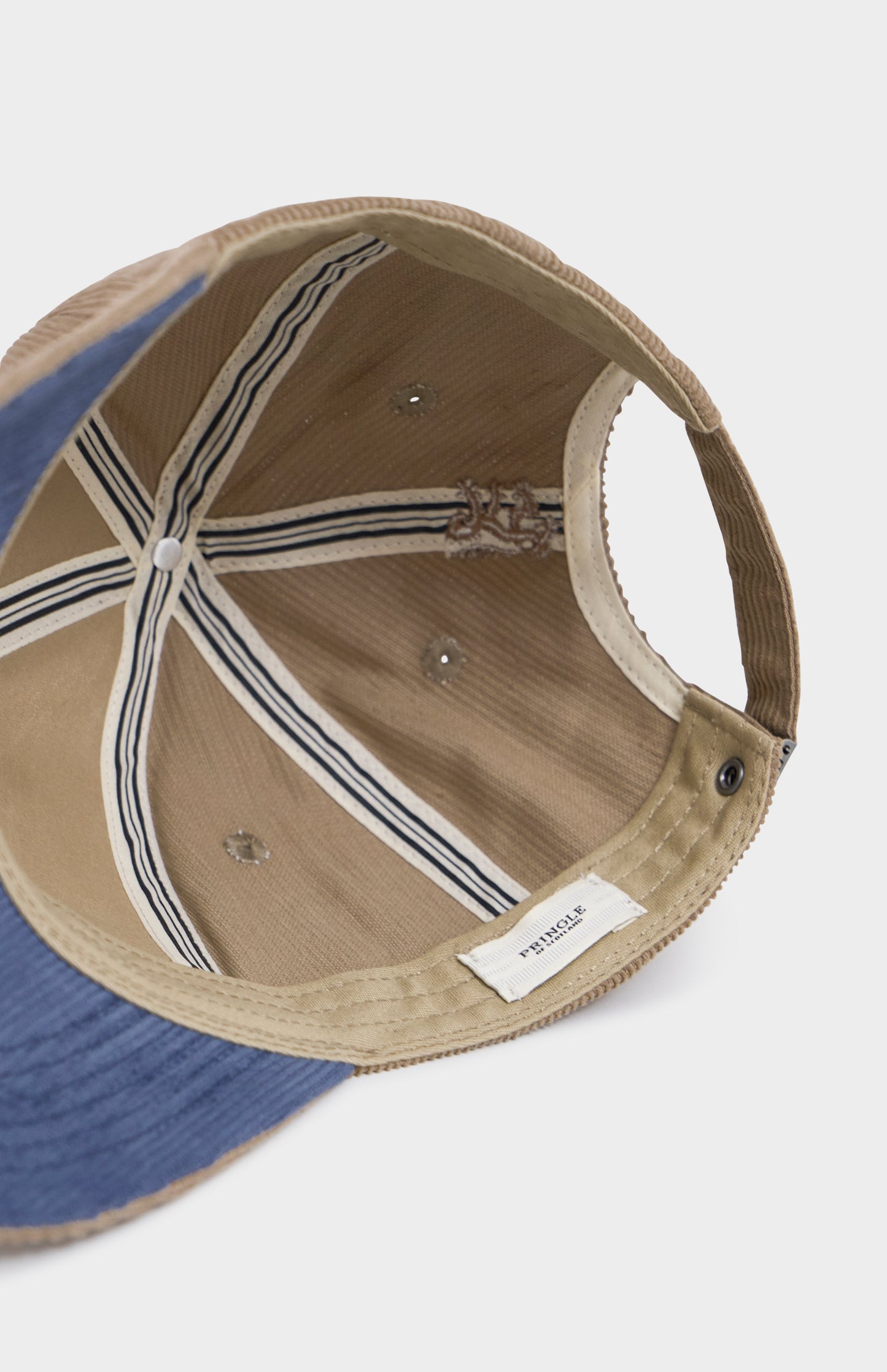 Beige cap with a small logo on a light gray background