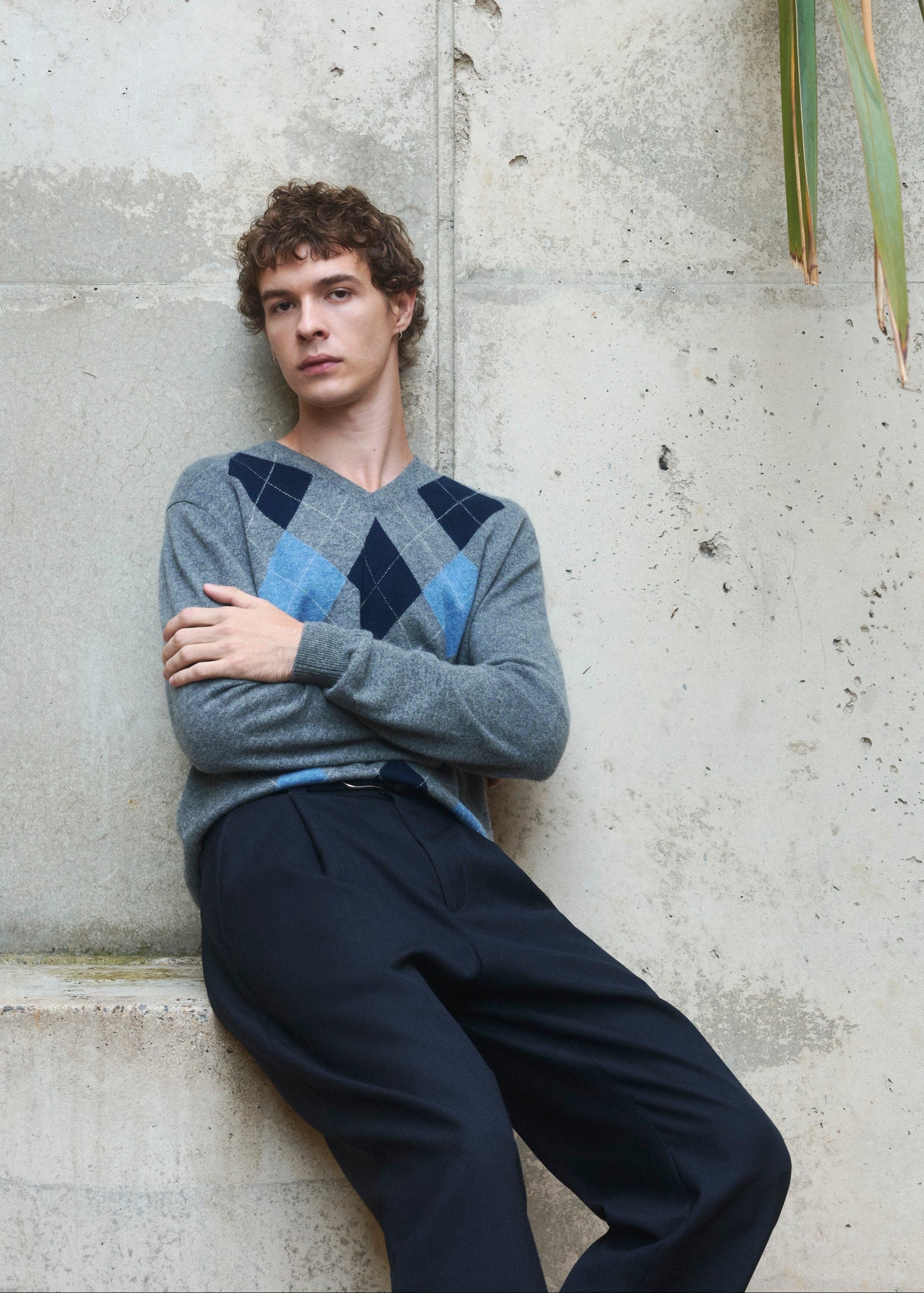 Person wearing an argyle patterned sweater by Pringle of Scotland.