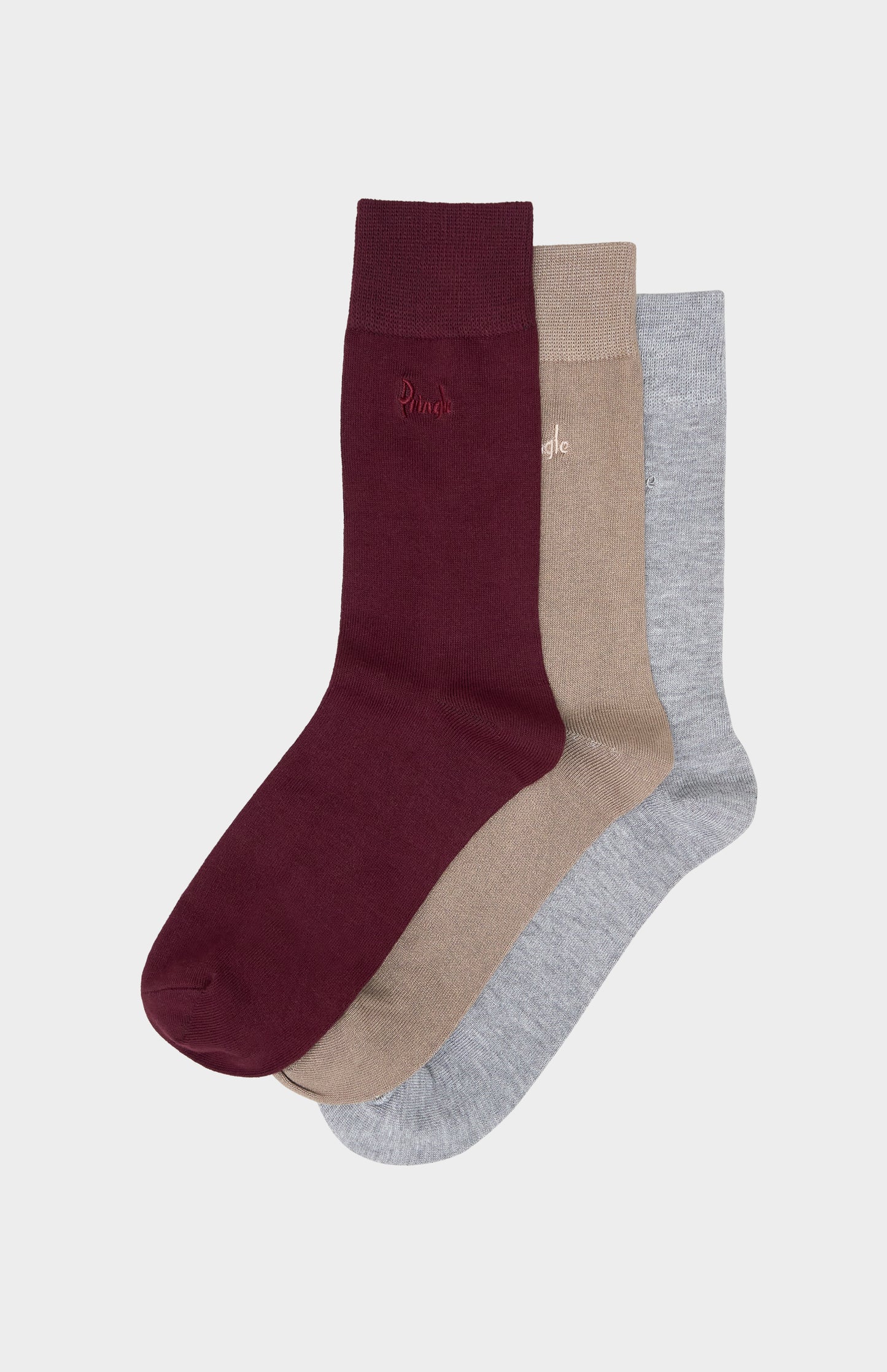 Three pairs of socks in burgundy, beige, and gray on a light gray background