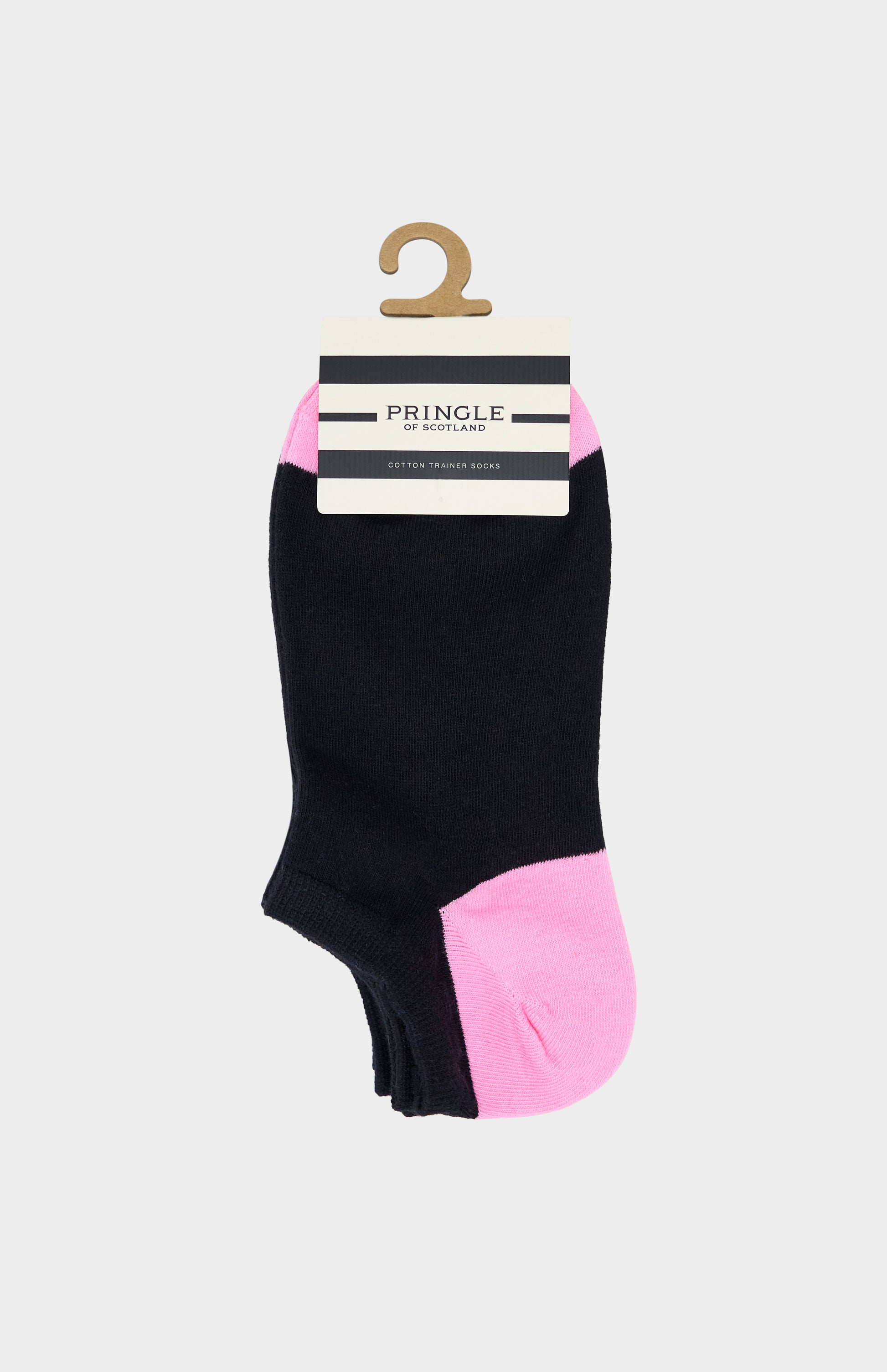 Black trainer socks with pink heel and toe accents on beige background