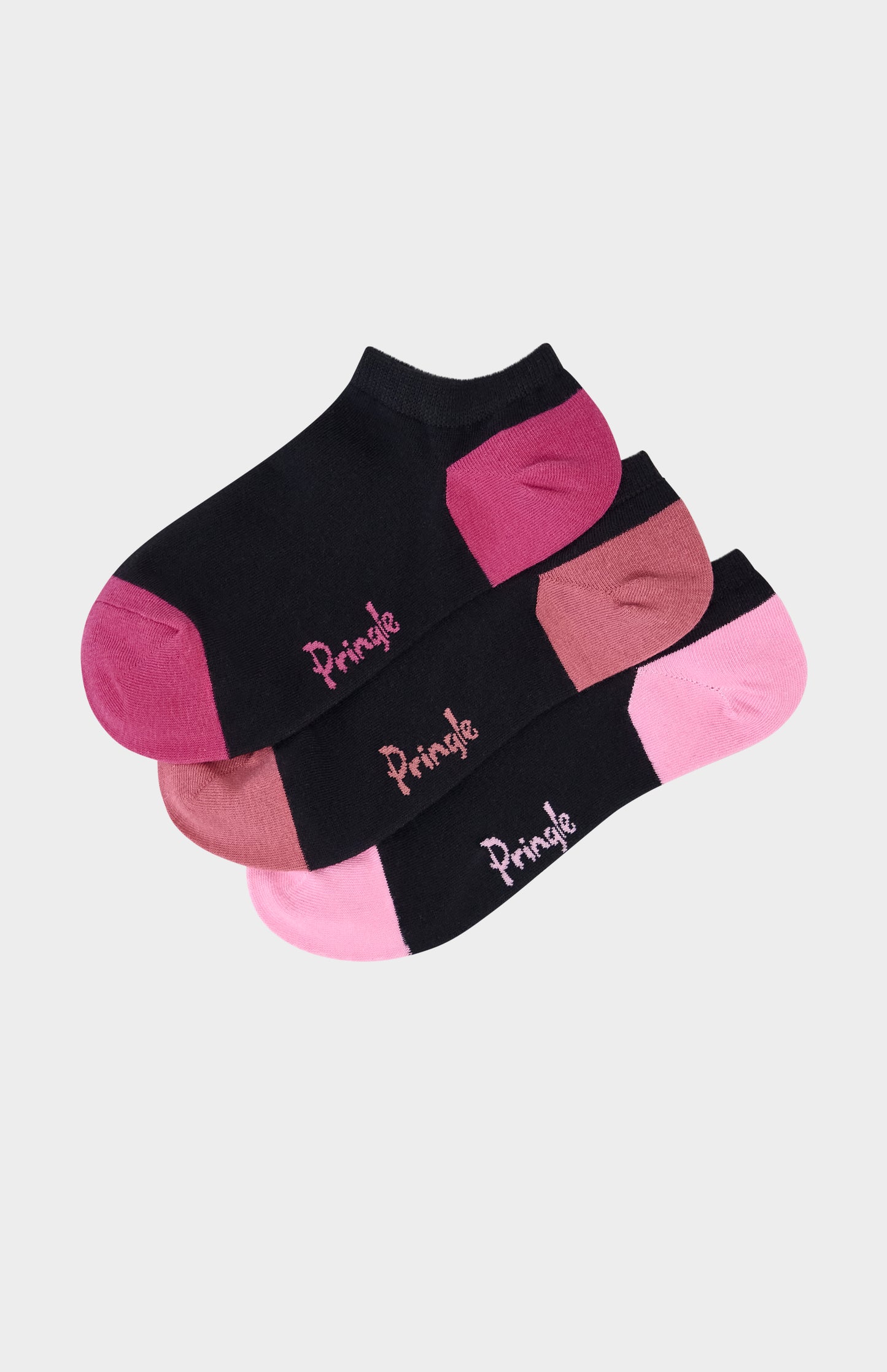 Black trainer socks with pink heel and toe accents on beige background