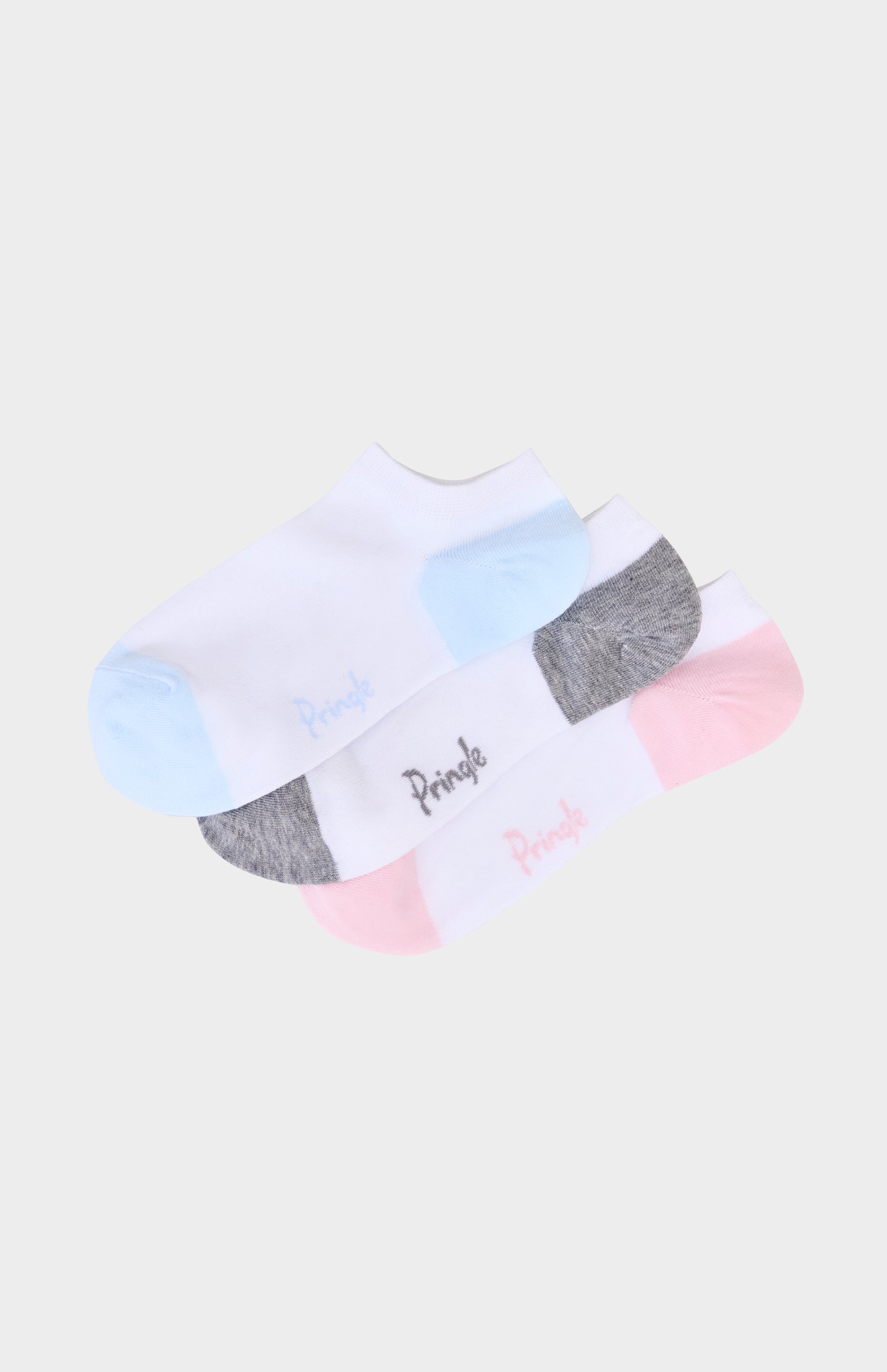 Three pairs of socks with different color accents on a light background