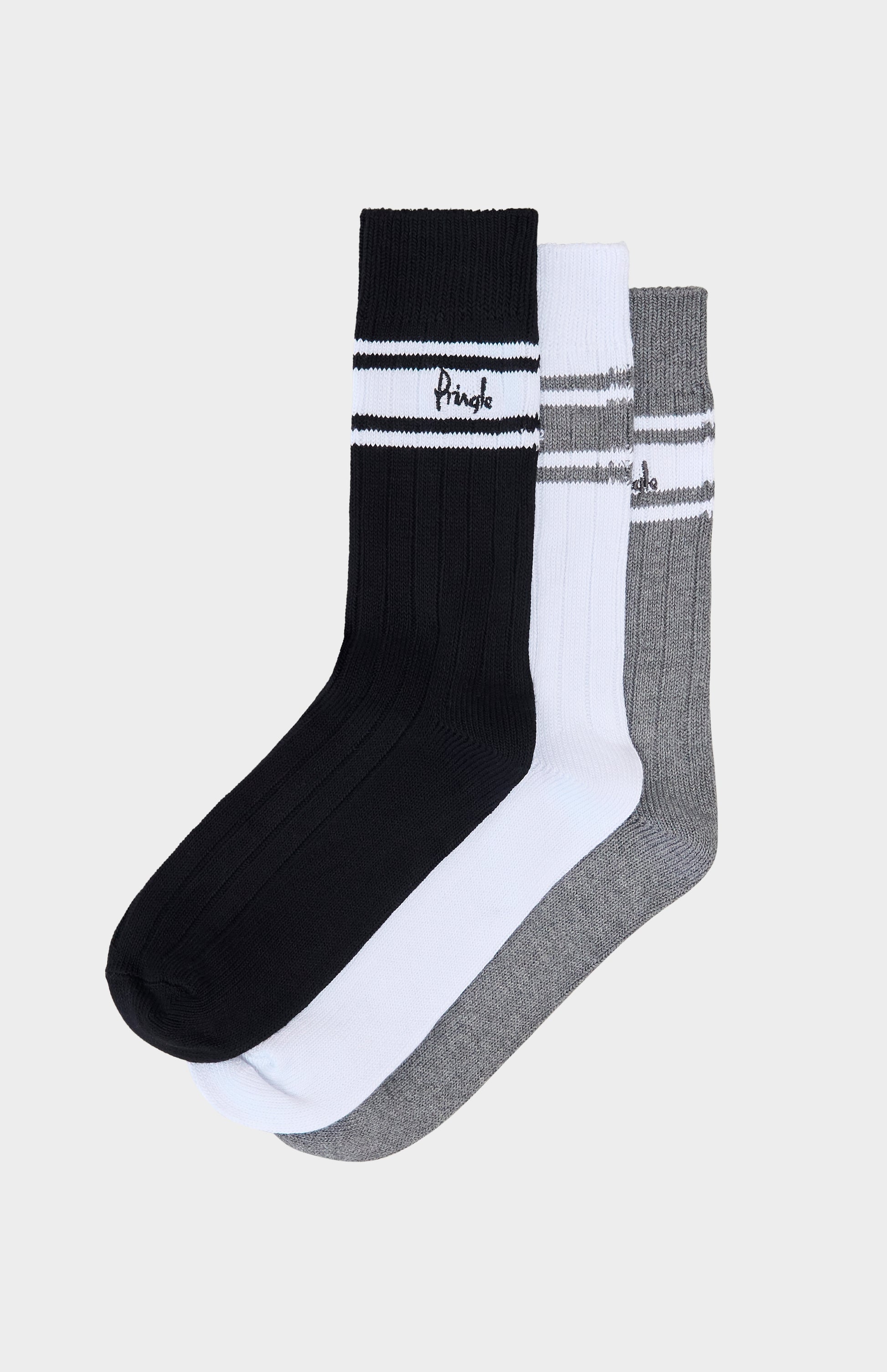 Three socks in black, white, and gray on a light beige background