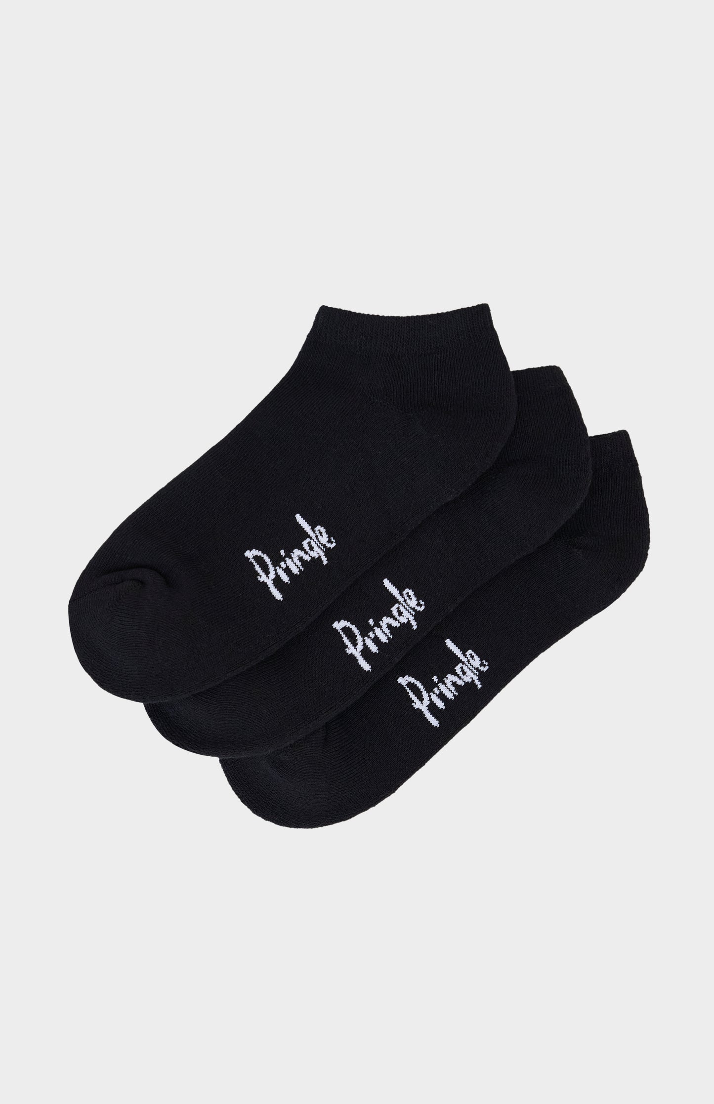 Black trainer socks with Pringle branding against light grey background