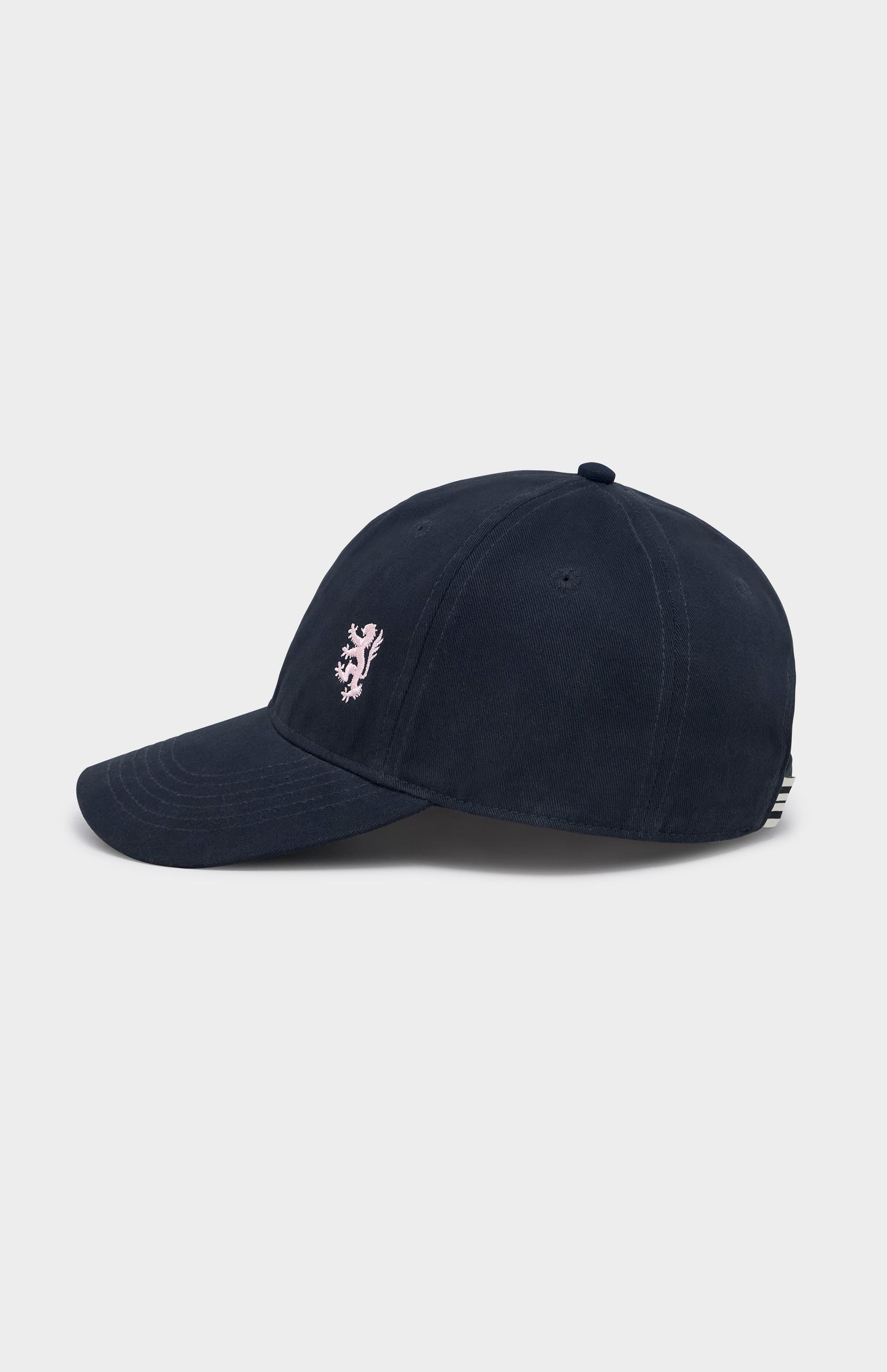 Navy baseball cap with light pink lion logo embroidery on the right hand side