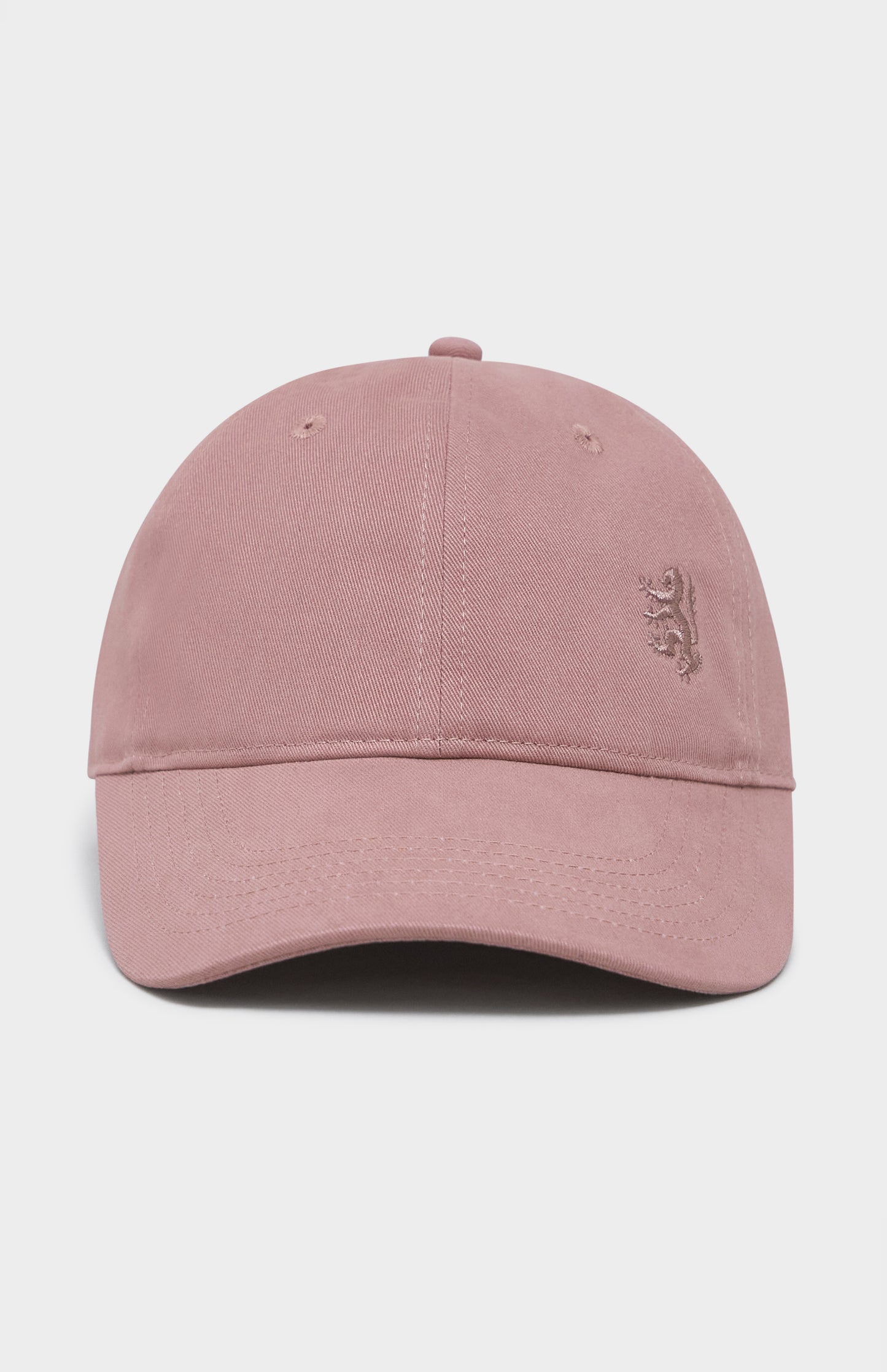 Dusty pink baseball cap with tonal lion logo embroidered on the right hand side
