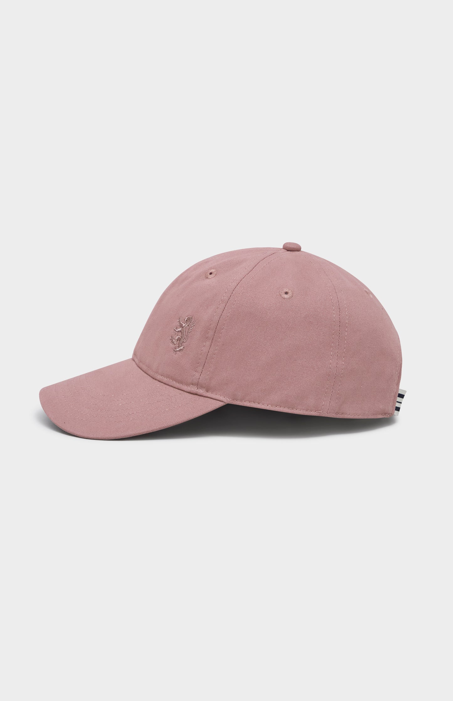 Dusty pink baseball cap with tonal lion logo embroidered on the right hand side