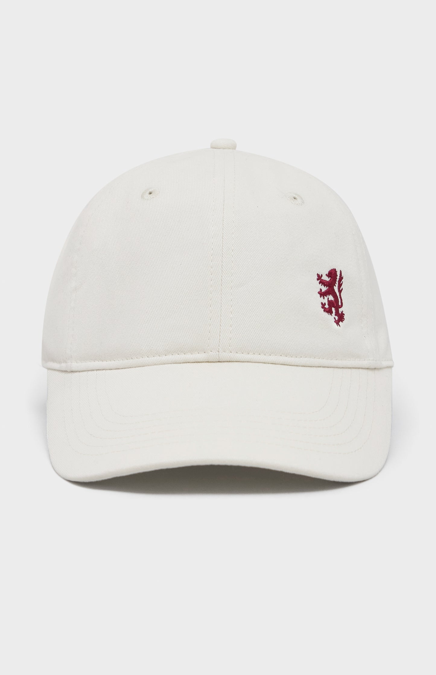 Ecru baseball cap with red lion embroidery on the right hand side