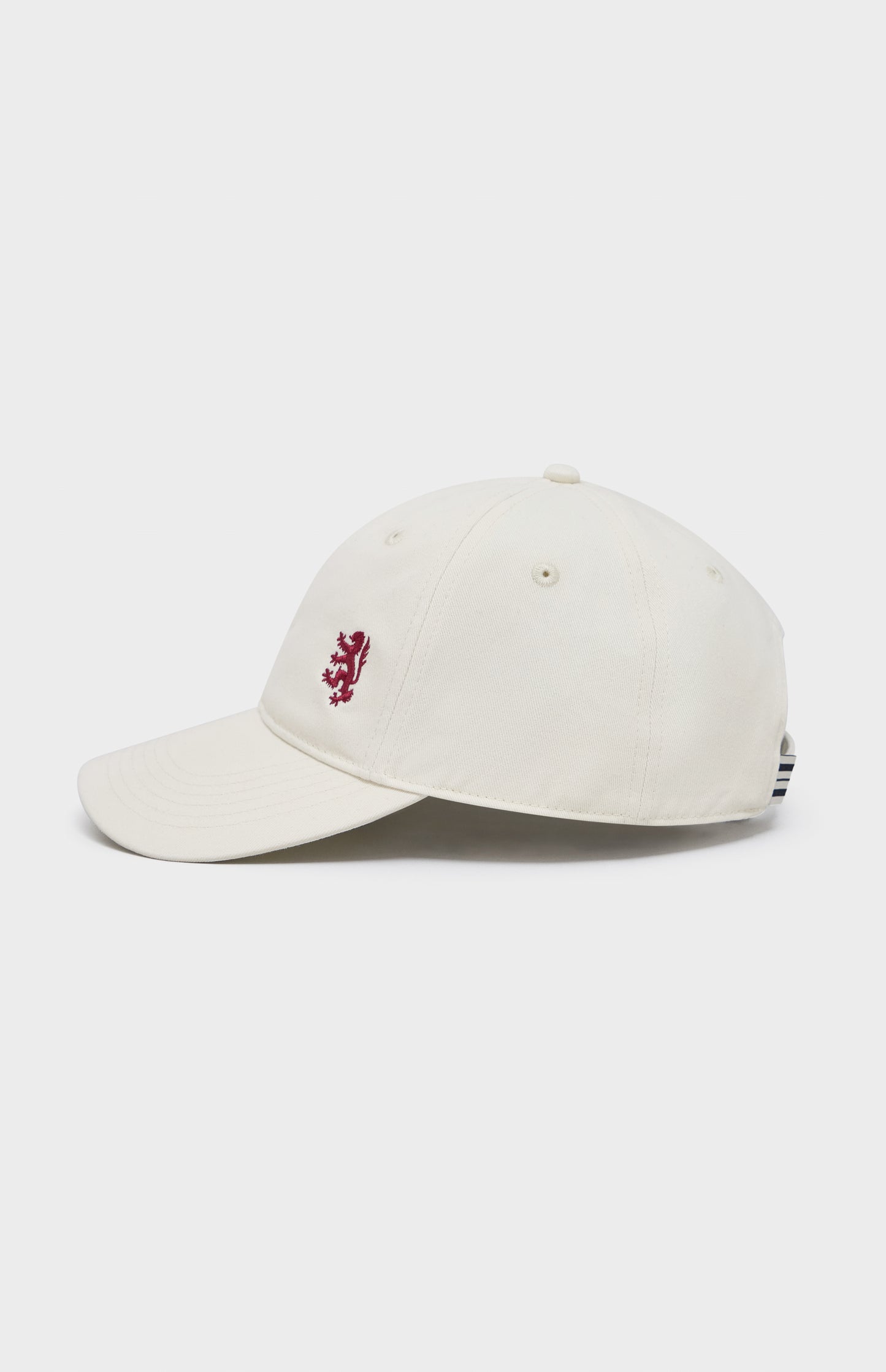 Ecru baseball cap with red lion embroidery on the right hand side