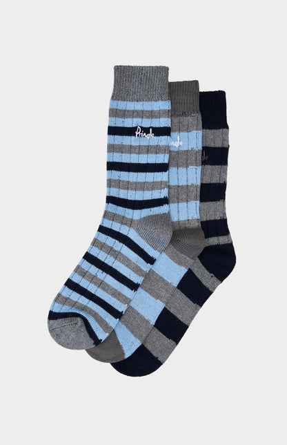 Three pairs of striped socks on a light gray background