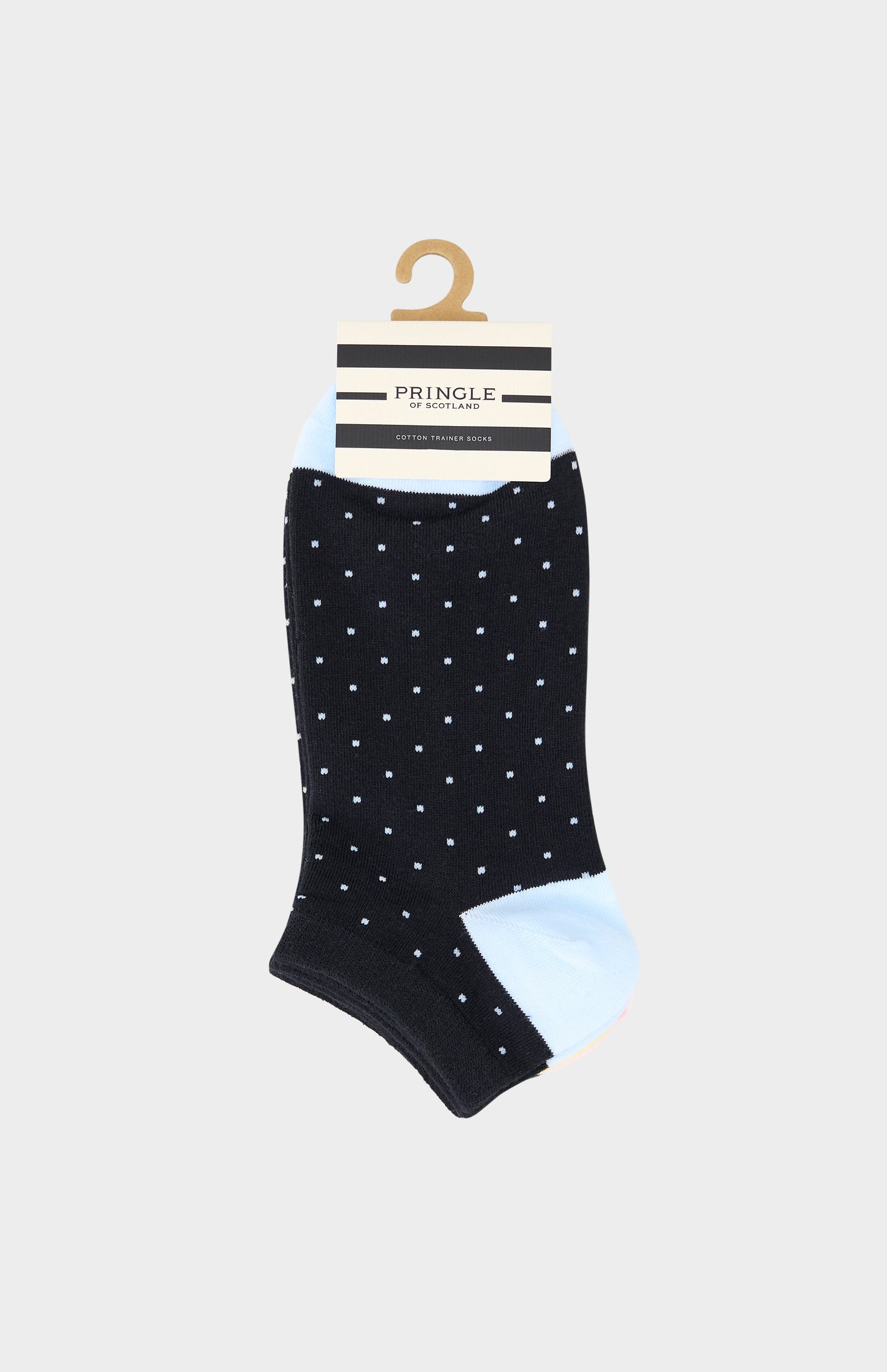 Trainer socks with light blue polka dots on a hanger against a white background
