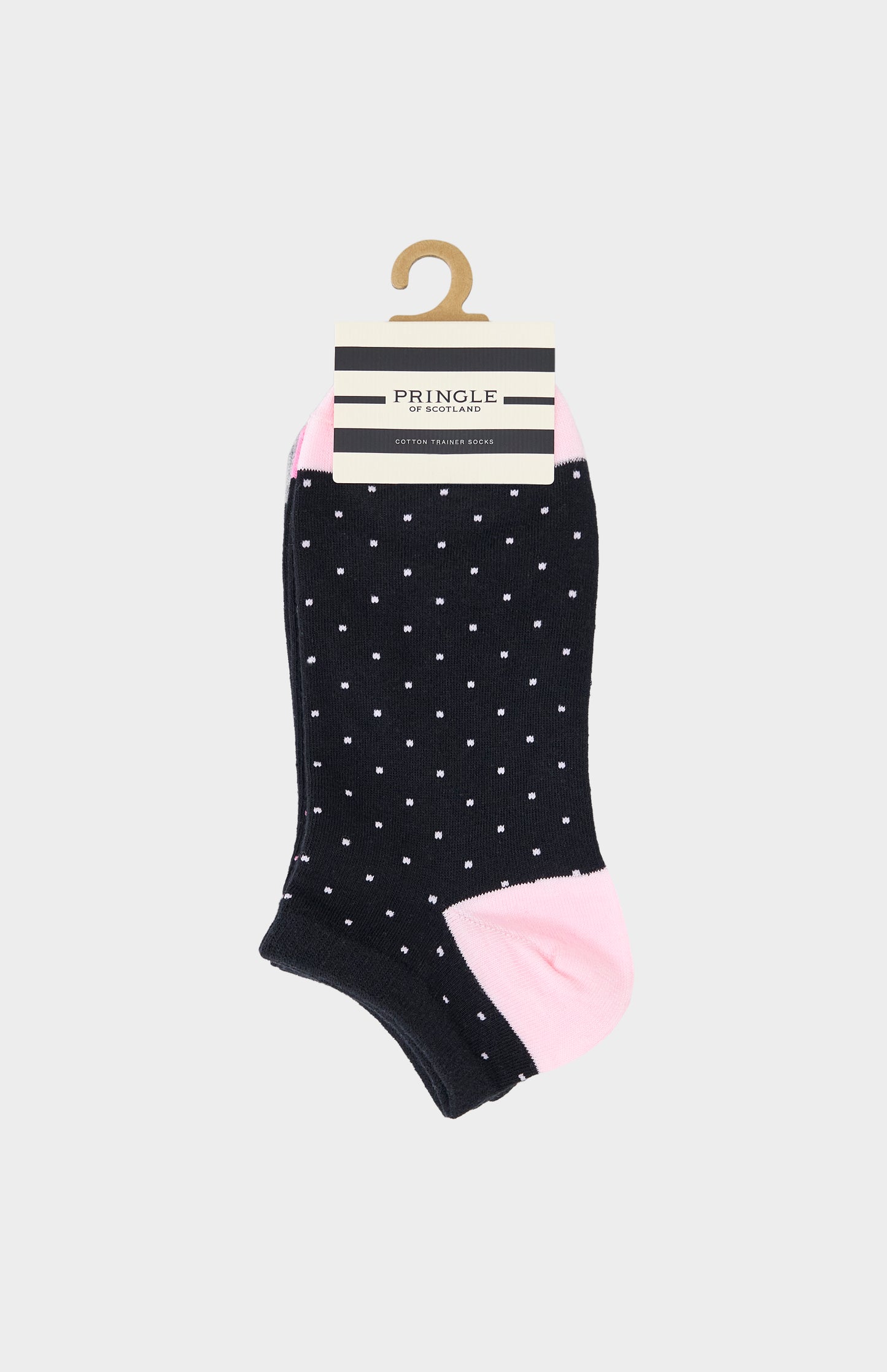 Black ankle sock with pink polka dots and pink toes on a hanger with Pringle packaging.