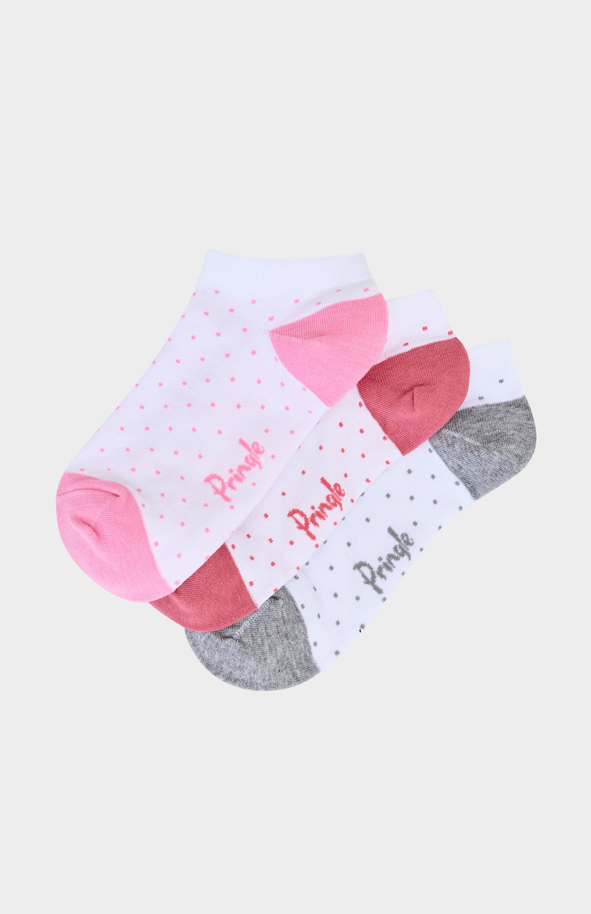 Set of three pairs of socks with pink and gray accents and polka dots on a light background