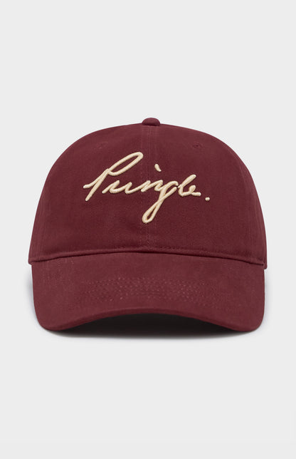 Maroon cap with gold embroidered text on a light gray background