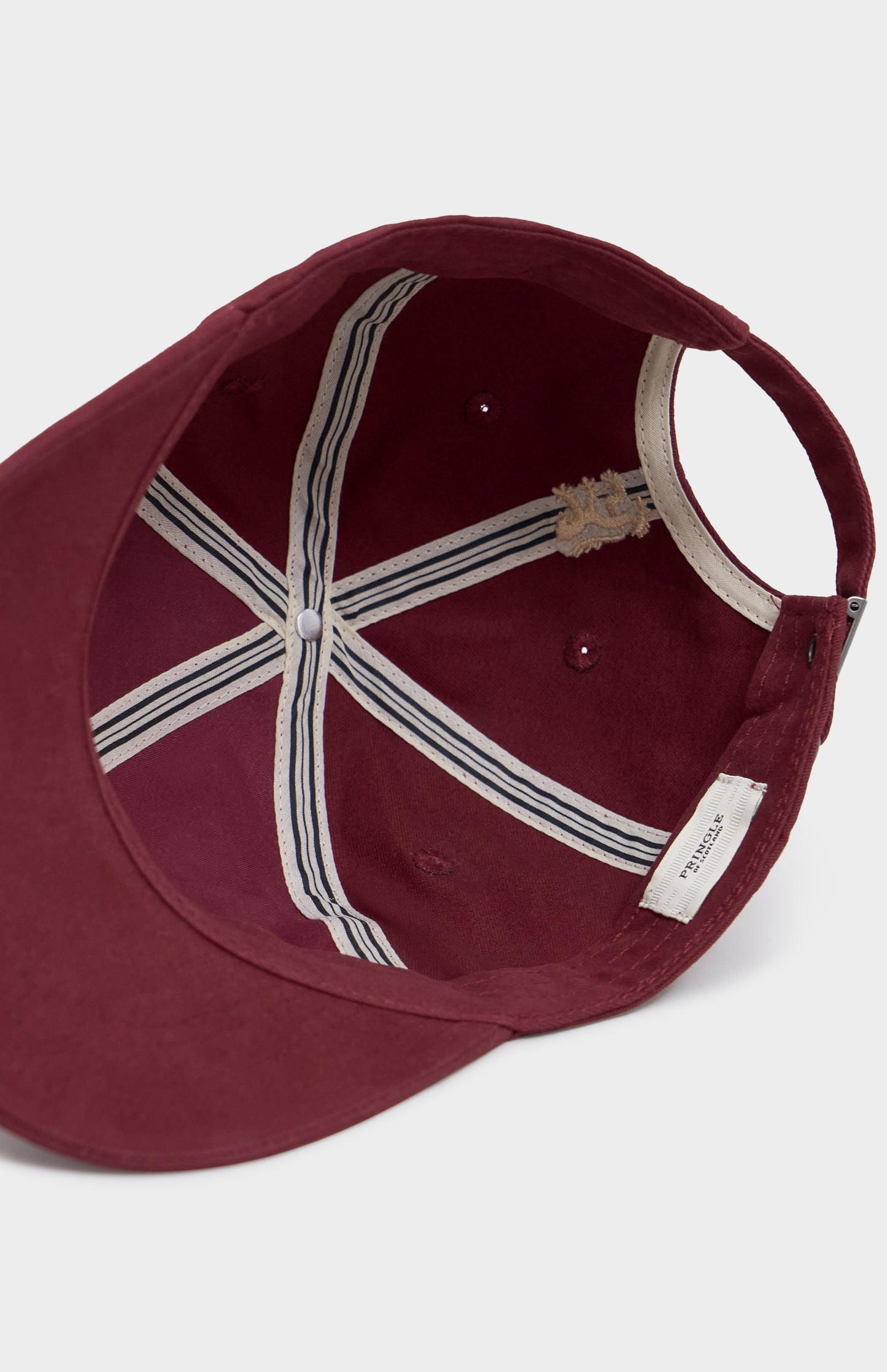 Maroon baseball cap with a white interior and brand label on a light gray background