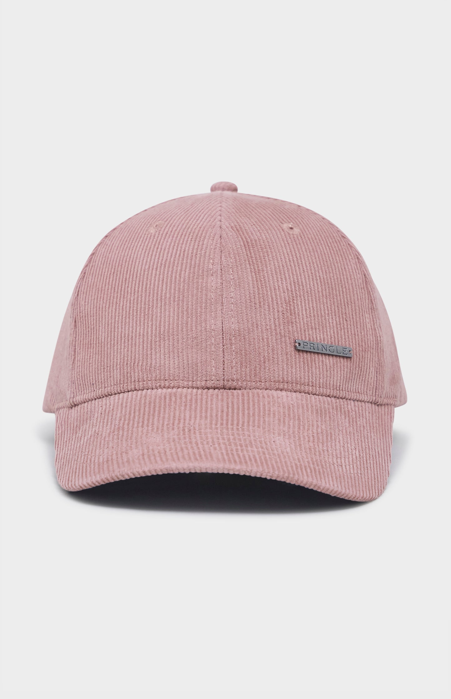 Dusty pink corduroy baseball cap with metal badging on the front