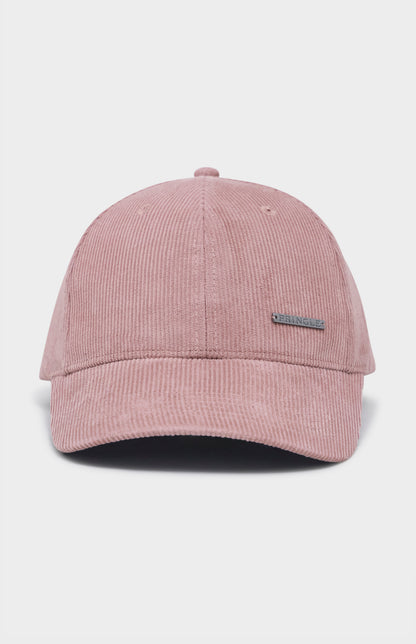 Dusty pink corduroy baseball cap with metal badging on the front