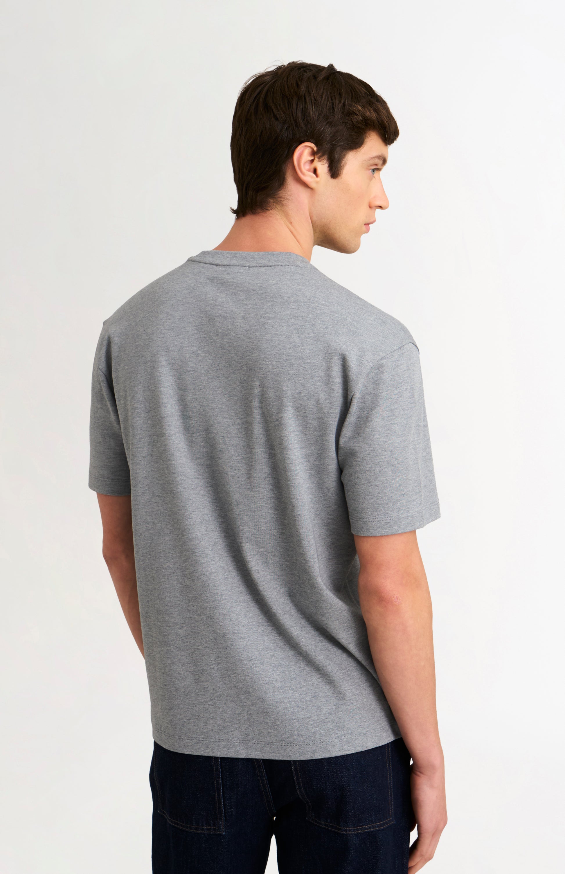 Man wearing a gray t-shirt on a white background