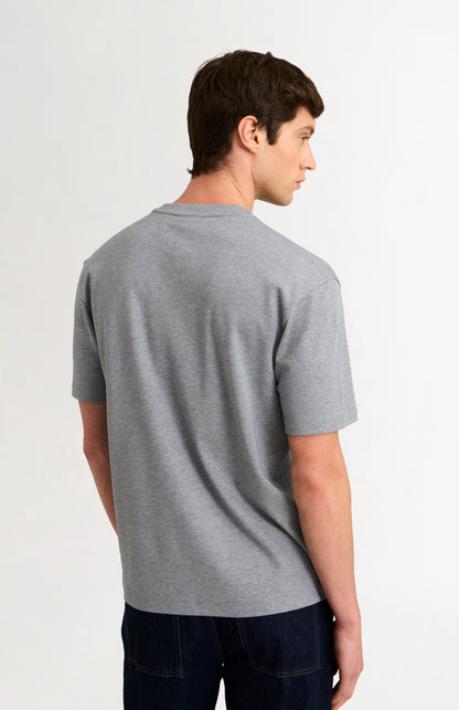 Man wearing a gray t-shirt on a white background