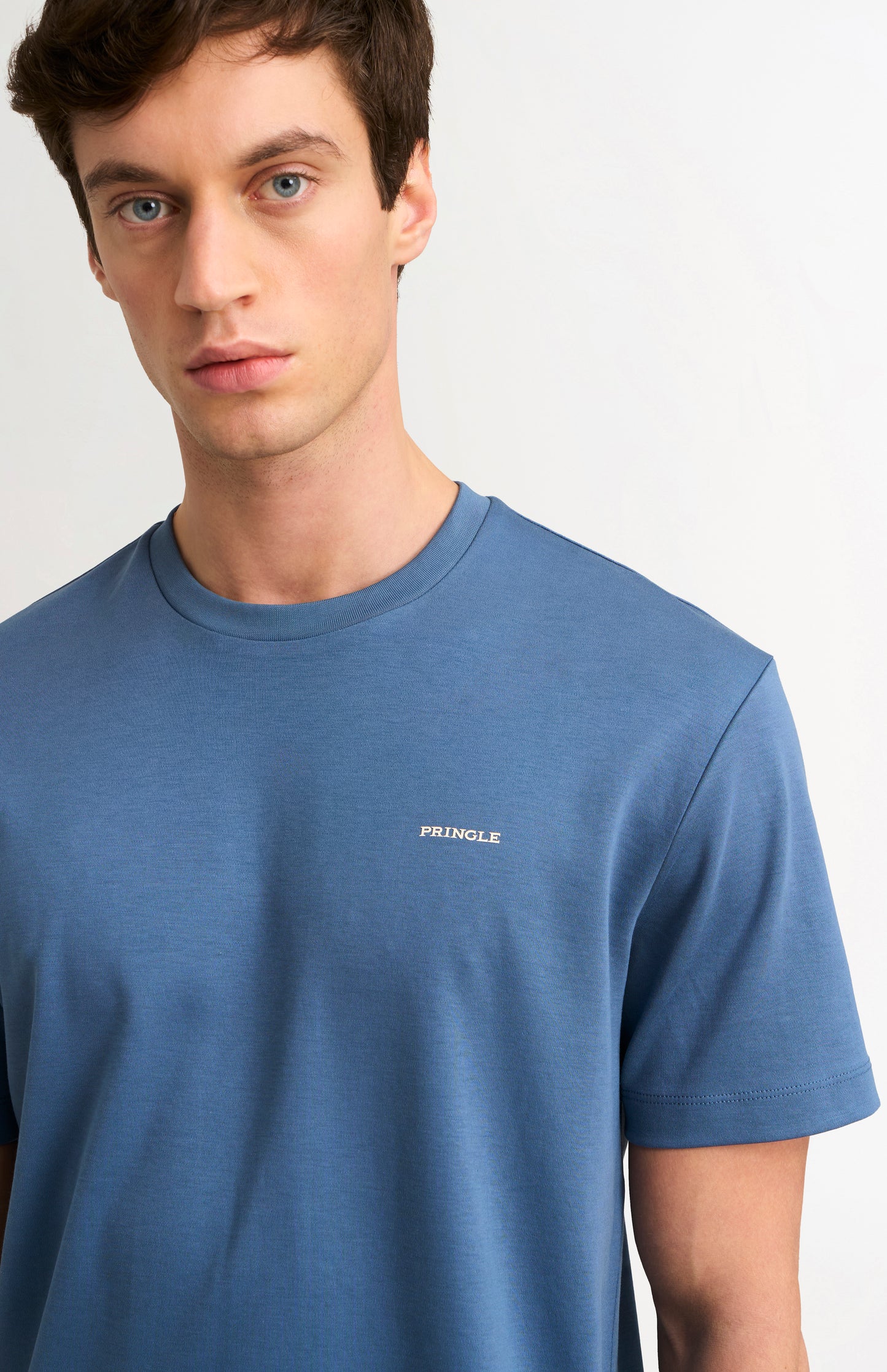Man wearing a blue t-shirt on a white background