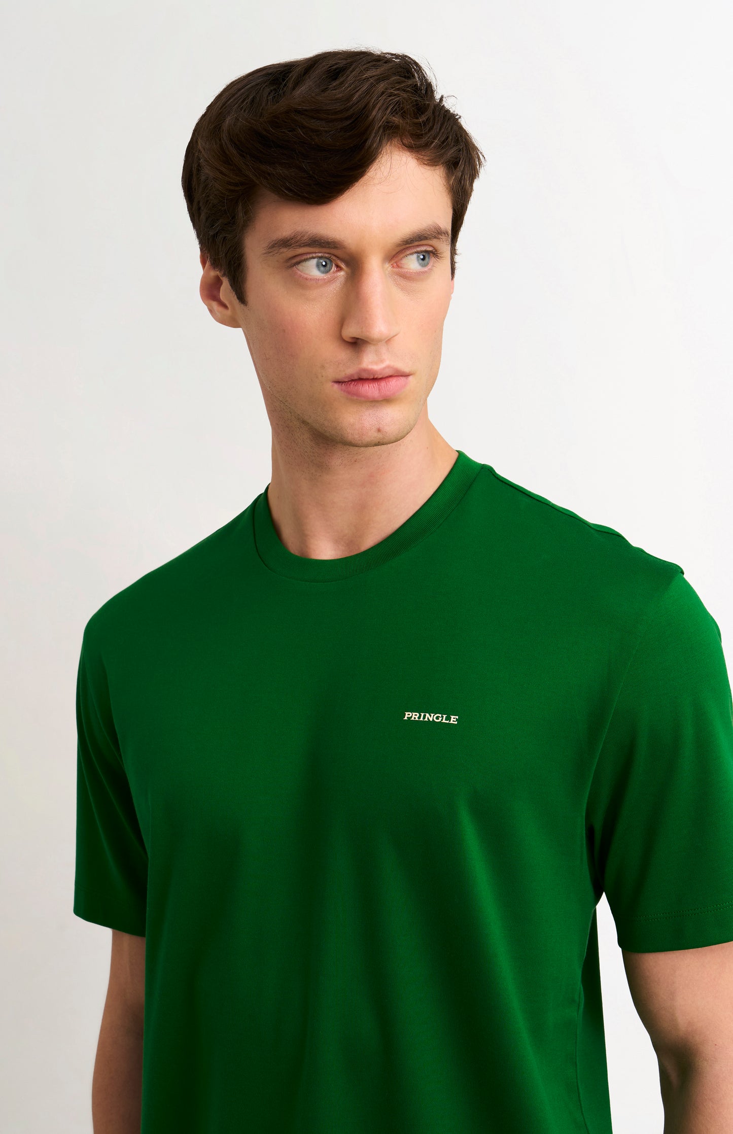 Man wearing a green t-shirt with PRINGLE logo on a white background