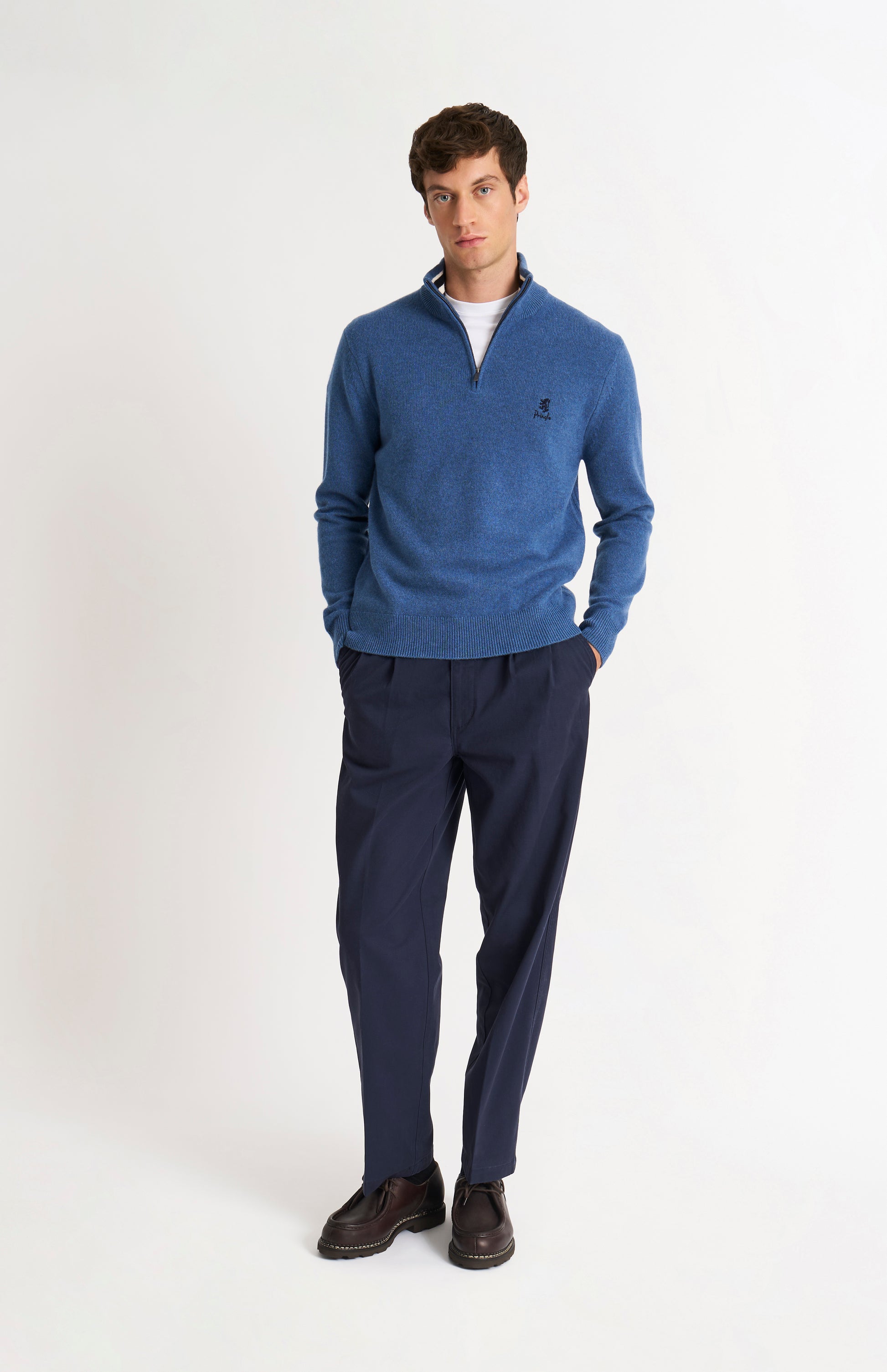 Pringle of Scotland Men’s Lambswool Qtr Zip Jumper In Bering Sea Blue and standing model