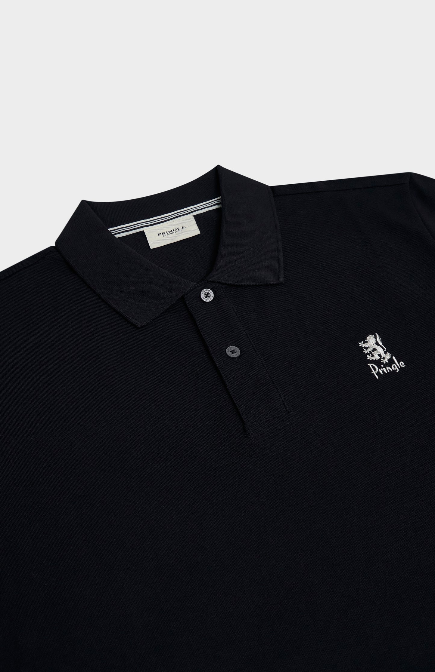Black polo shirt with a logo on a light gray background