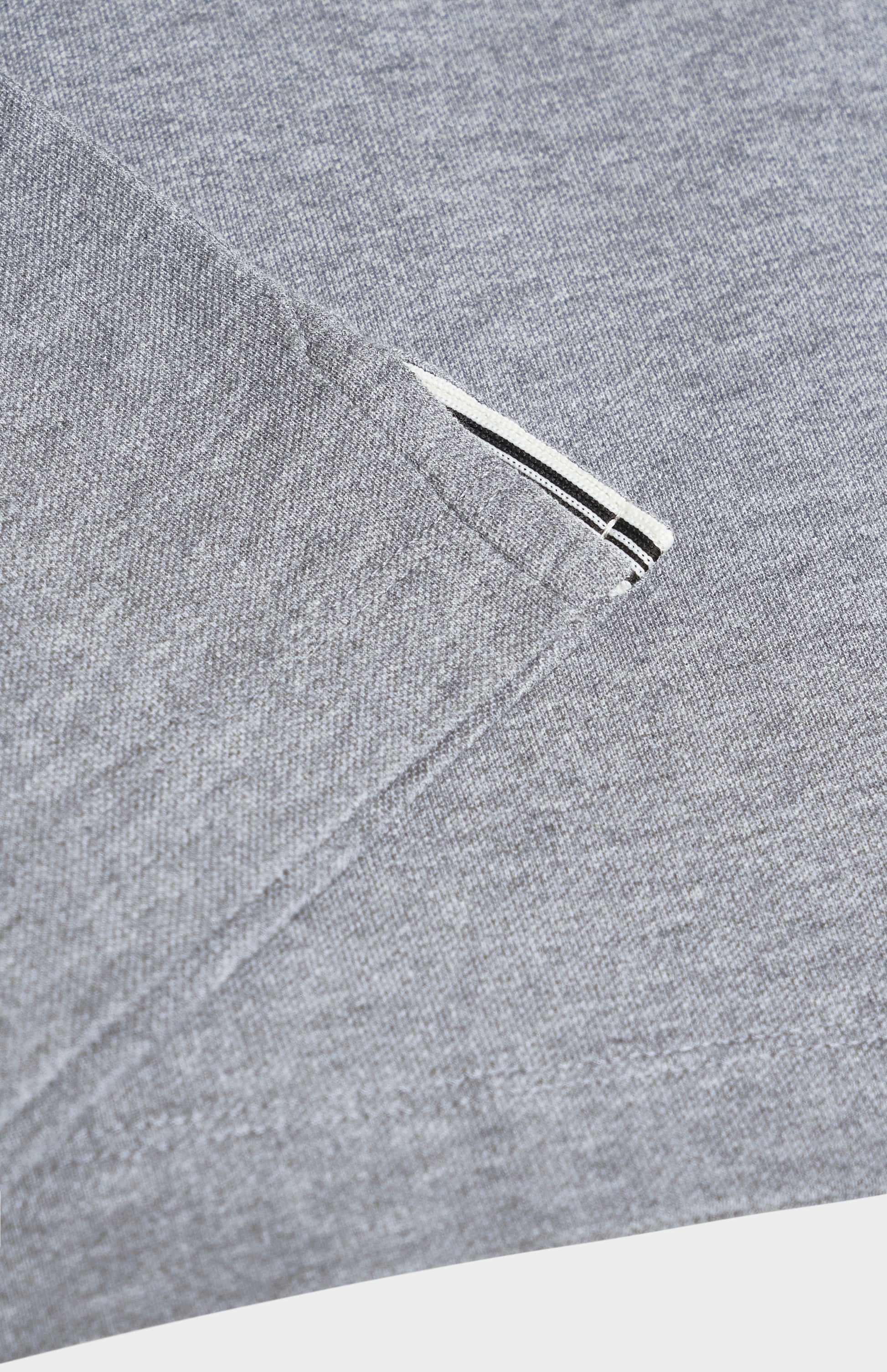 Close-up of a gray polo shirt on a white background
