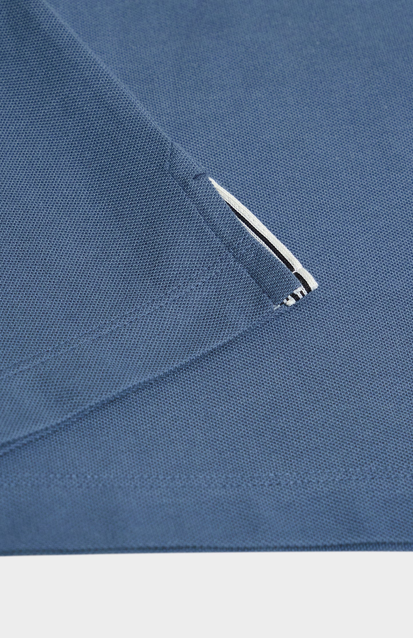 Close-up of a blue fabric detail on a white background