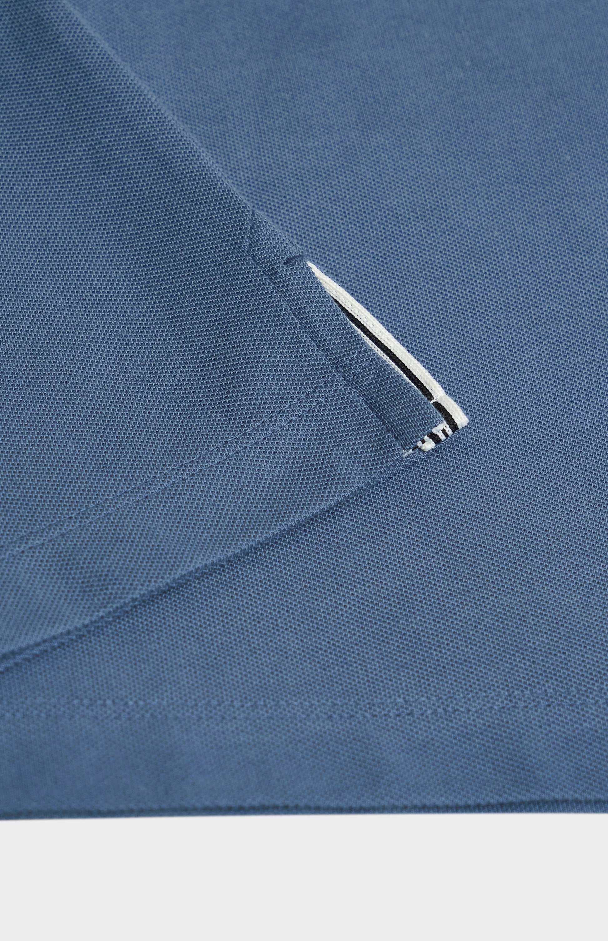 Close-up of a blue fabric detail on a white background