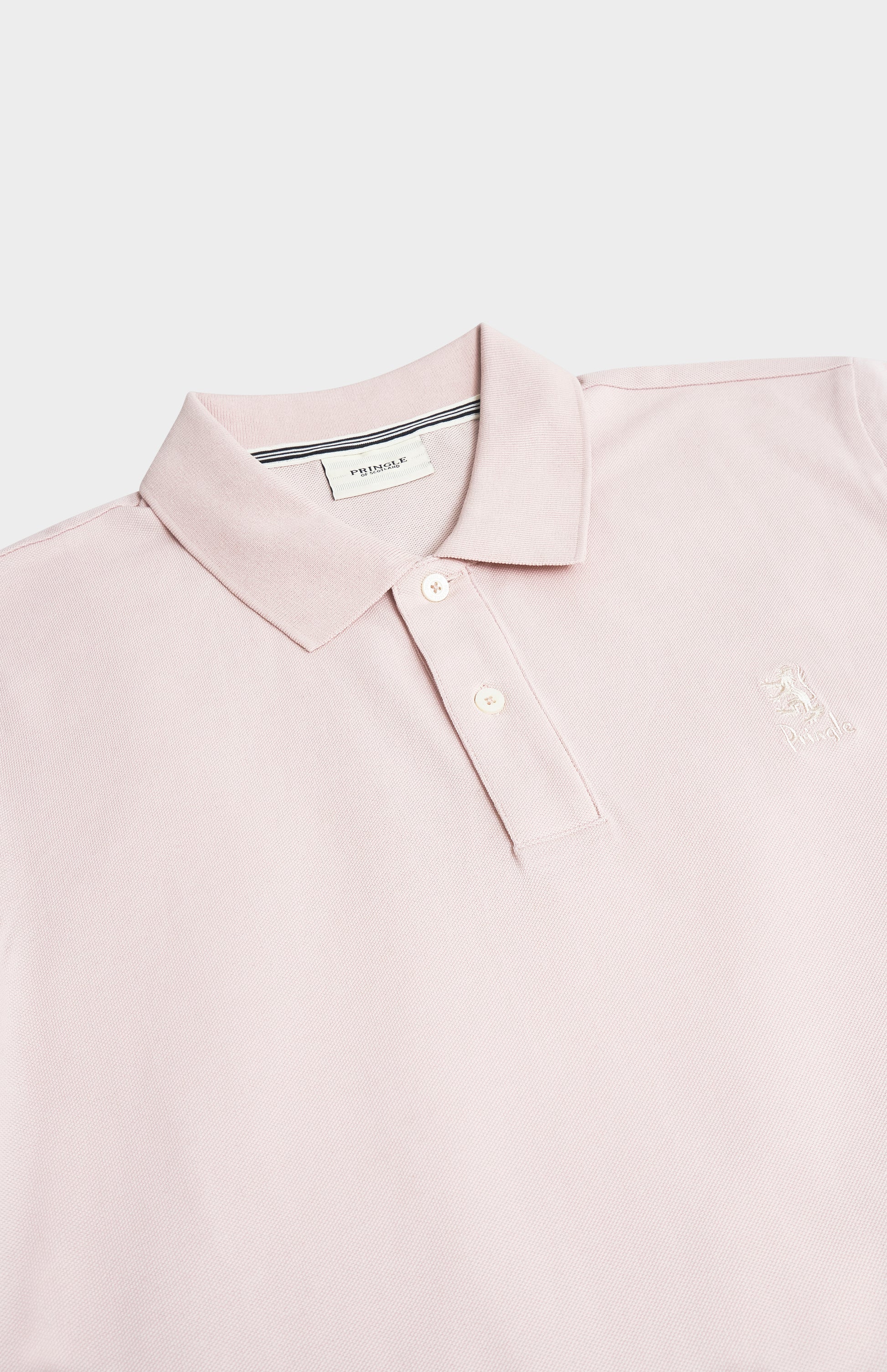 Pink polo shirt with a brand label on a light gray background