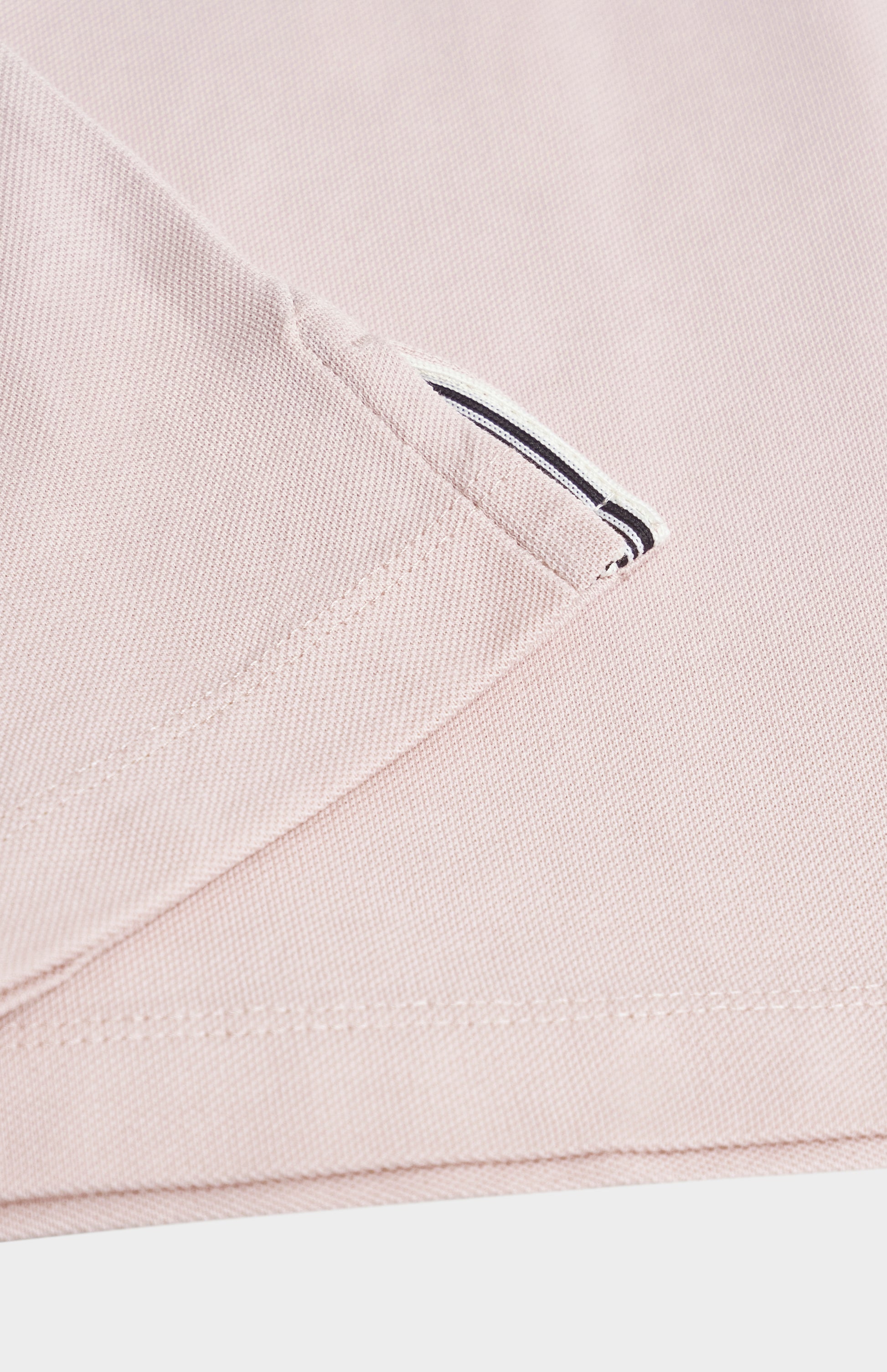 Close-up of a light pink fabric on a white background