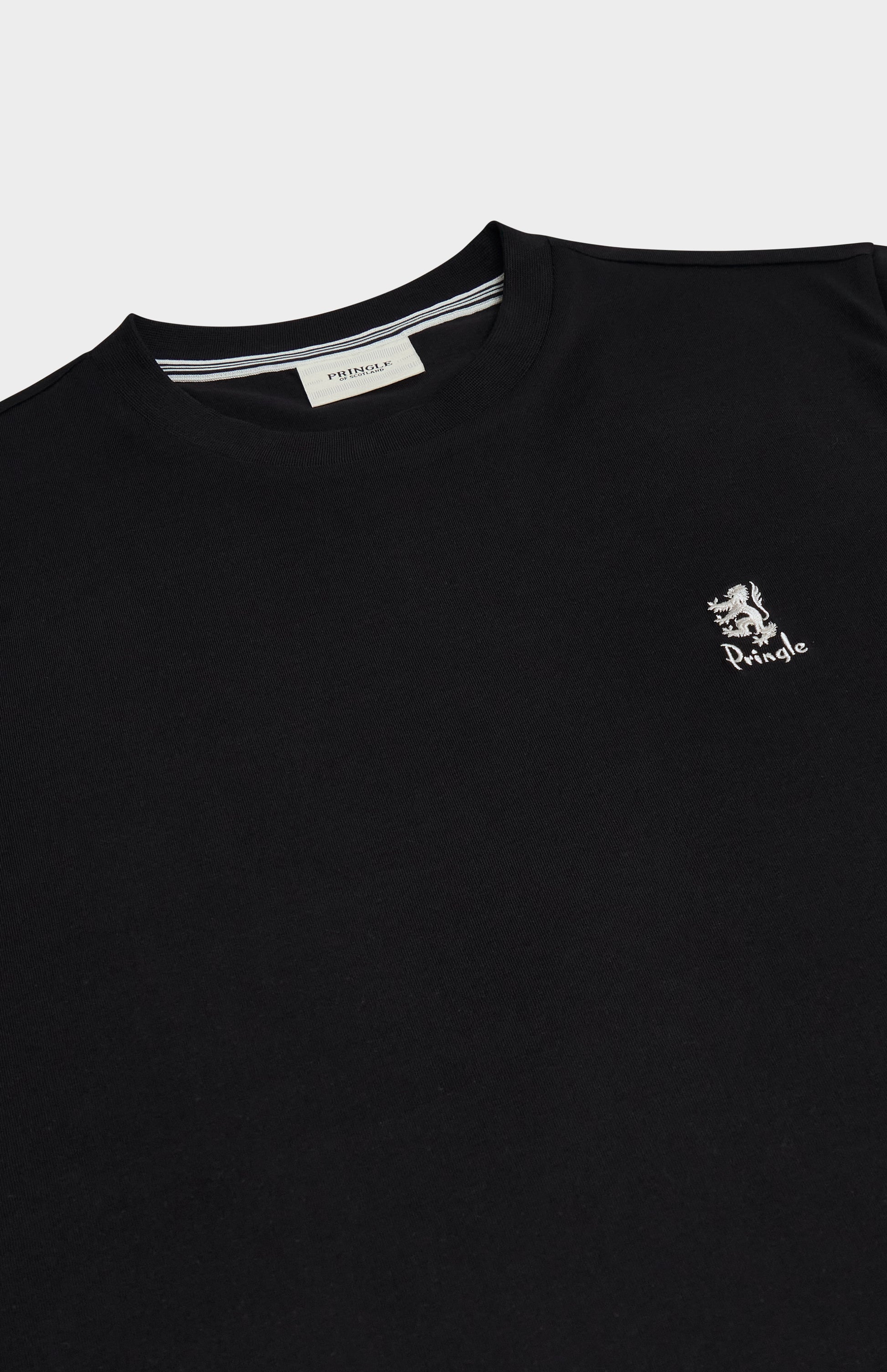 Black t-shirt with a small logo on the chest against a light gray background