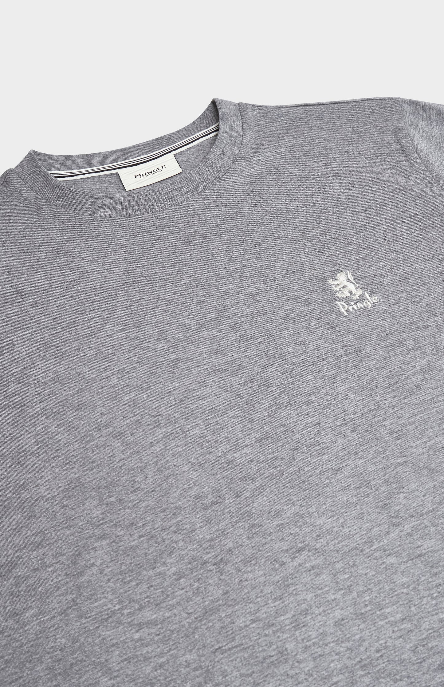 Close up of a grey t-shirt with a white brand logo on a white background