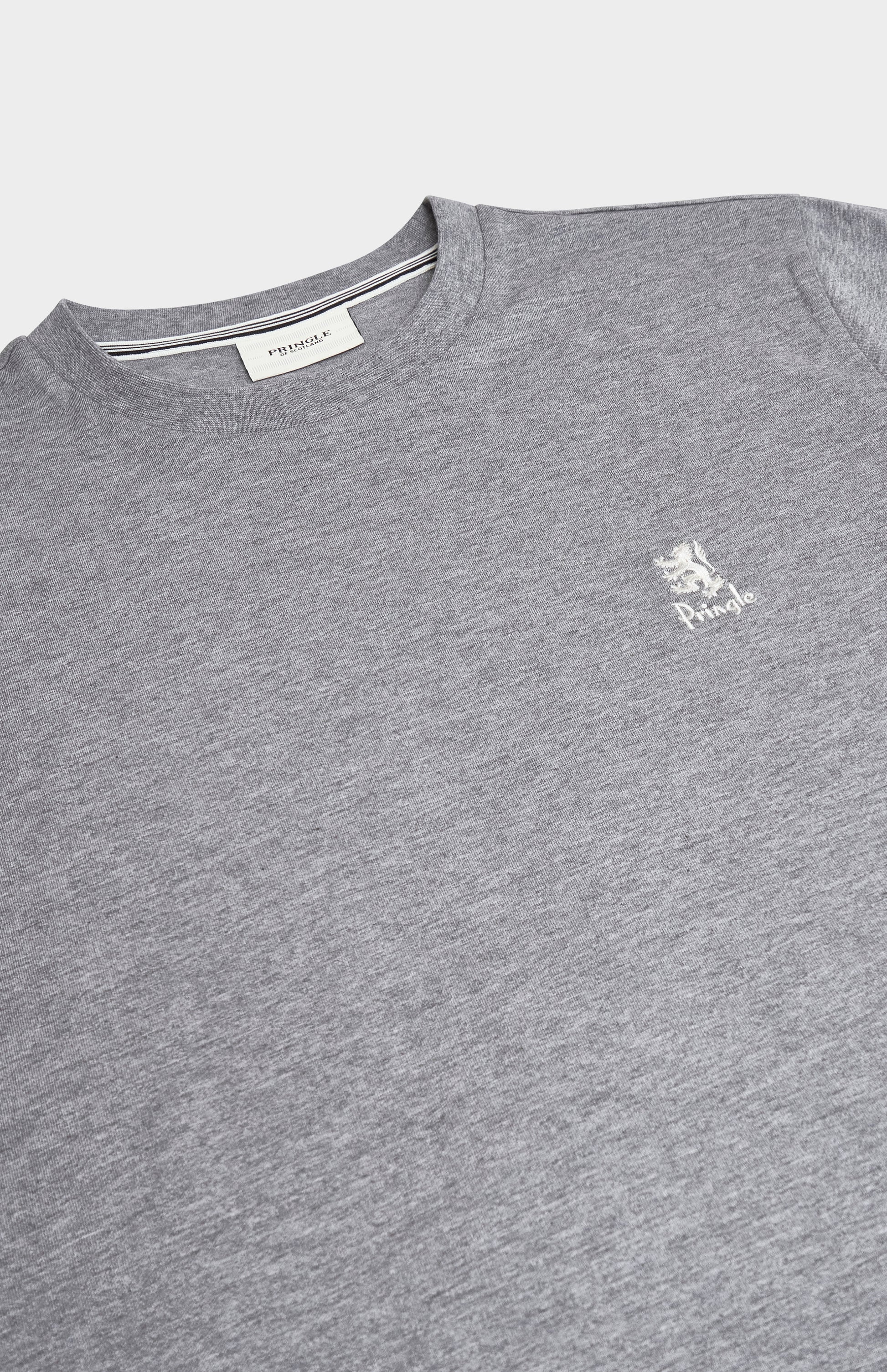 Close up of a grey t-shirt with a white brand logo on a white background