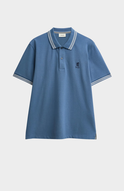 Mid blue polo with tipping details and Pringle logo on upper side of chest against light grey background