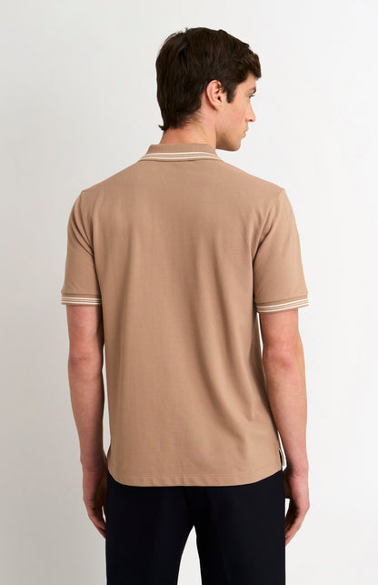 Back shot of model wearing a mushroom light brown polo with tipping details