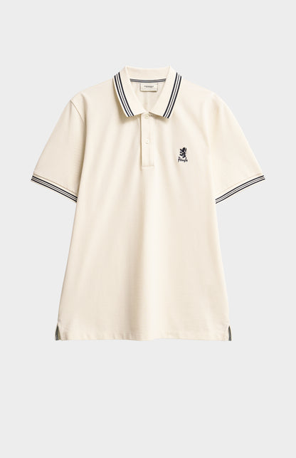 Beige polo shirt with black trim on a light gray background