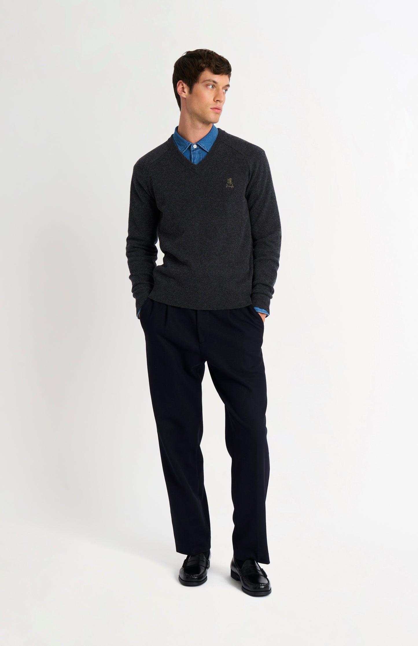 Pringle of Scotland Men’s Lambswool V Neck Jumper In Charcoal on standing model