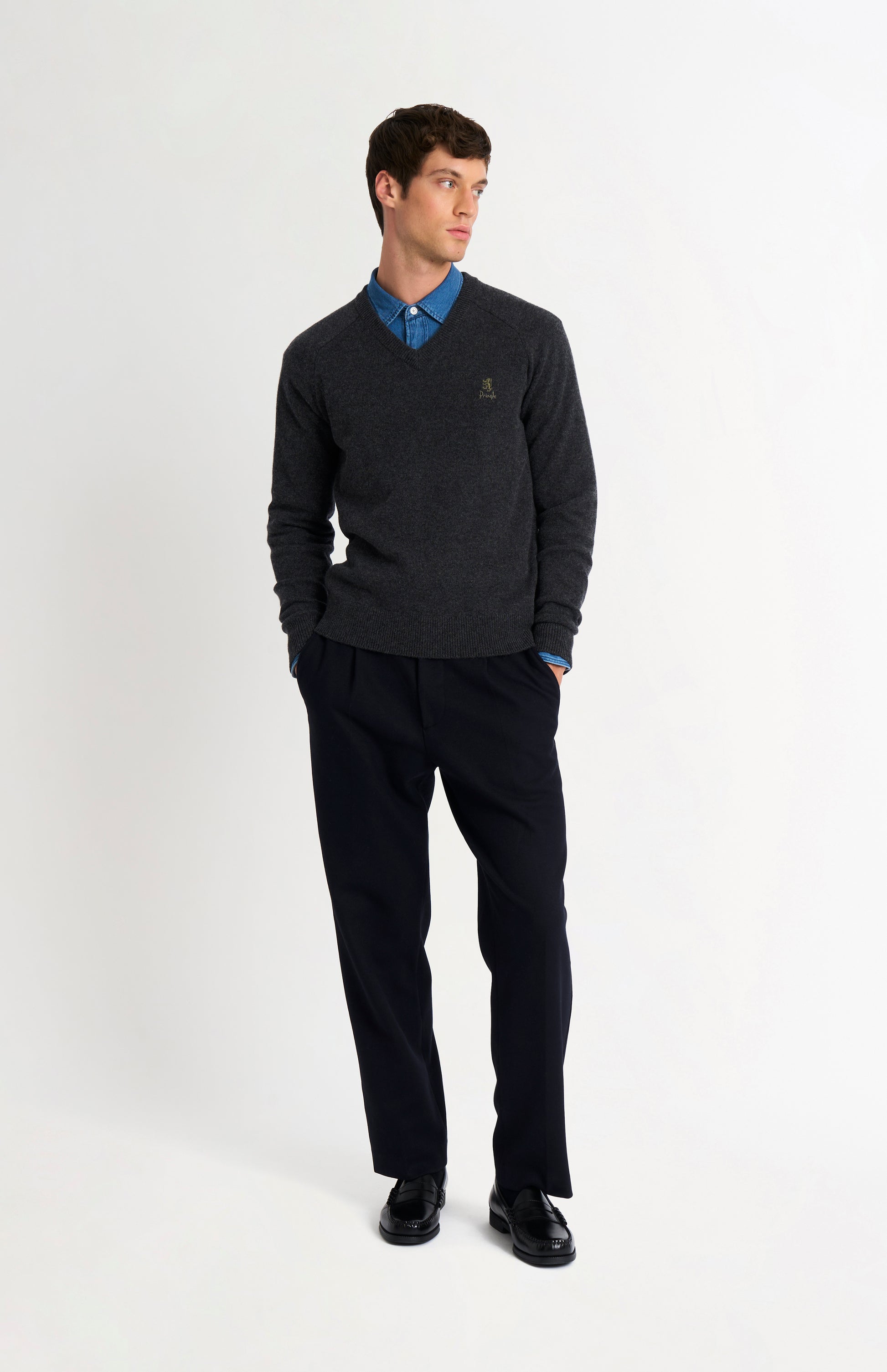 Pringle of Scotland Men’s Lambswool V Neck Jumper In Charcoal on standing model