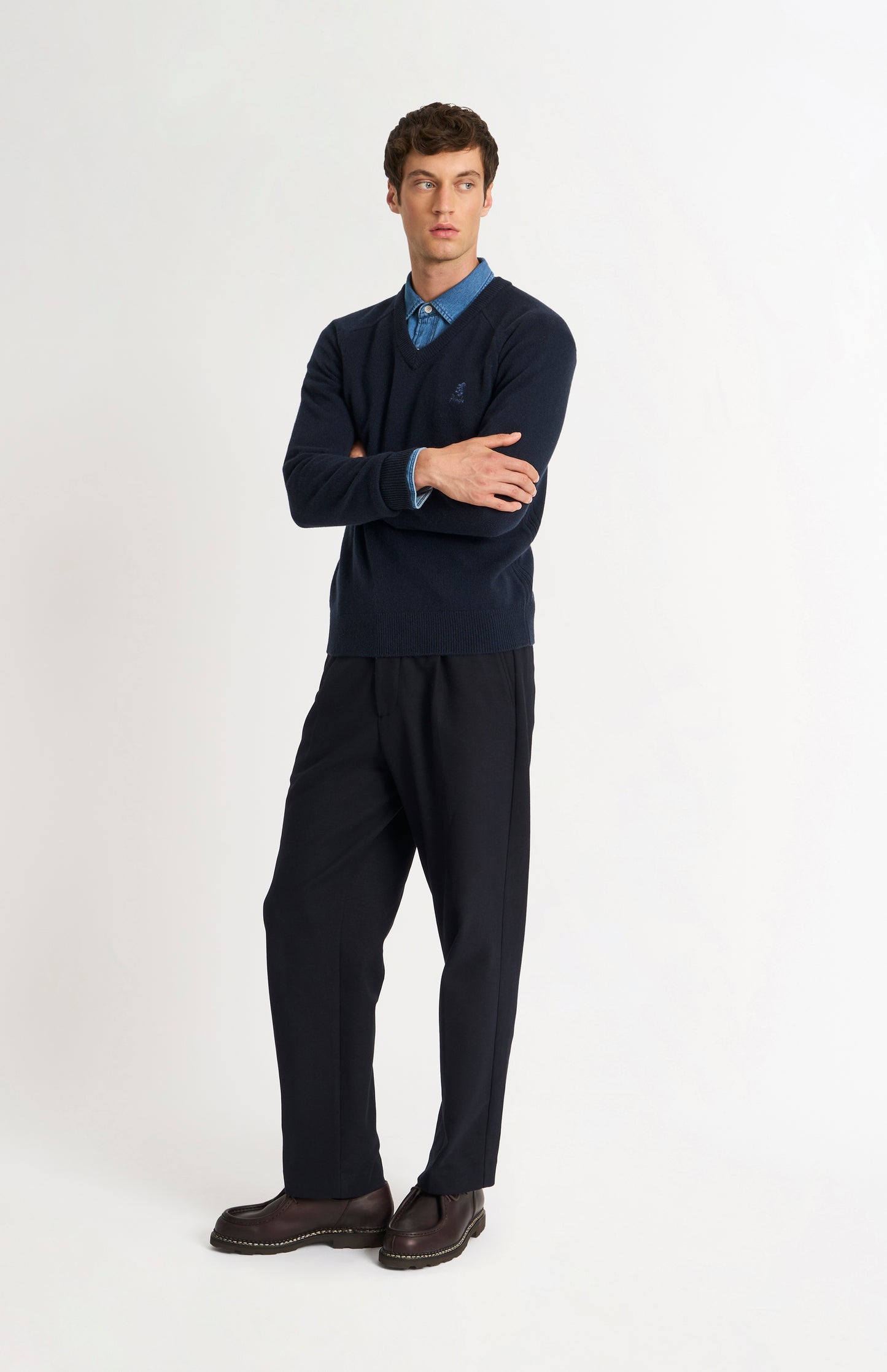 Pringle of Scotland Men’s Lambswool V Neck Jumper In Navy Blue on standing model