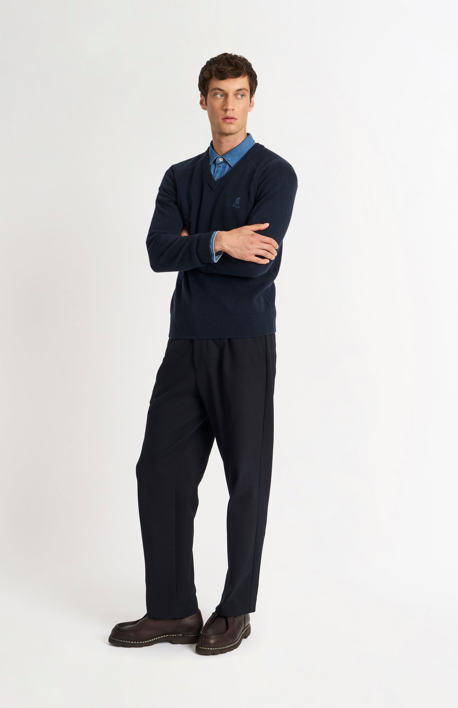 Pringle of Scotland Men’s Lambswool V Neck Jumper In Navy Blue on standing model