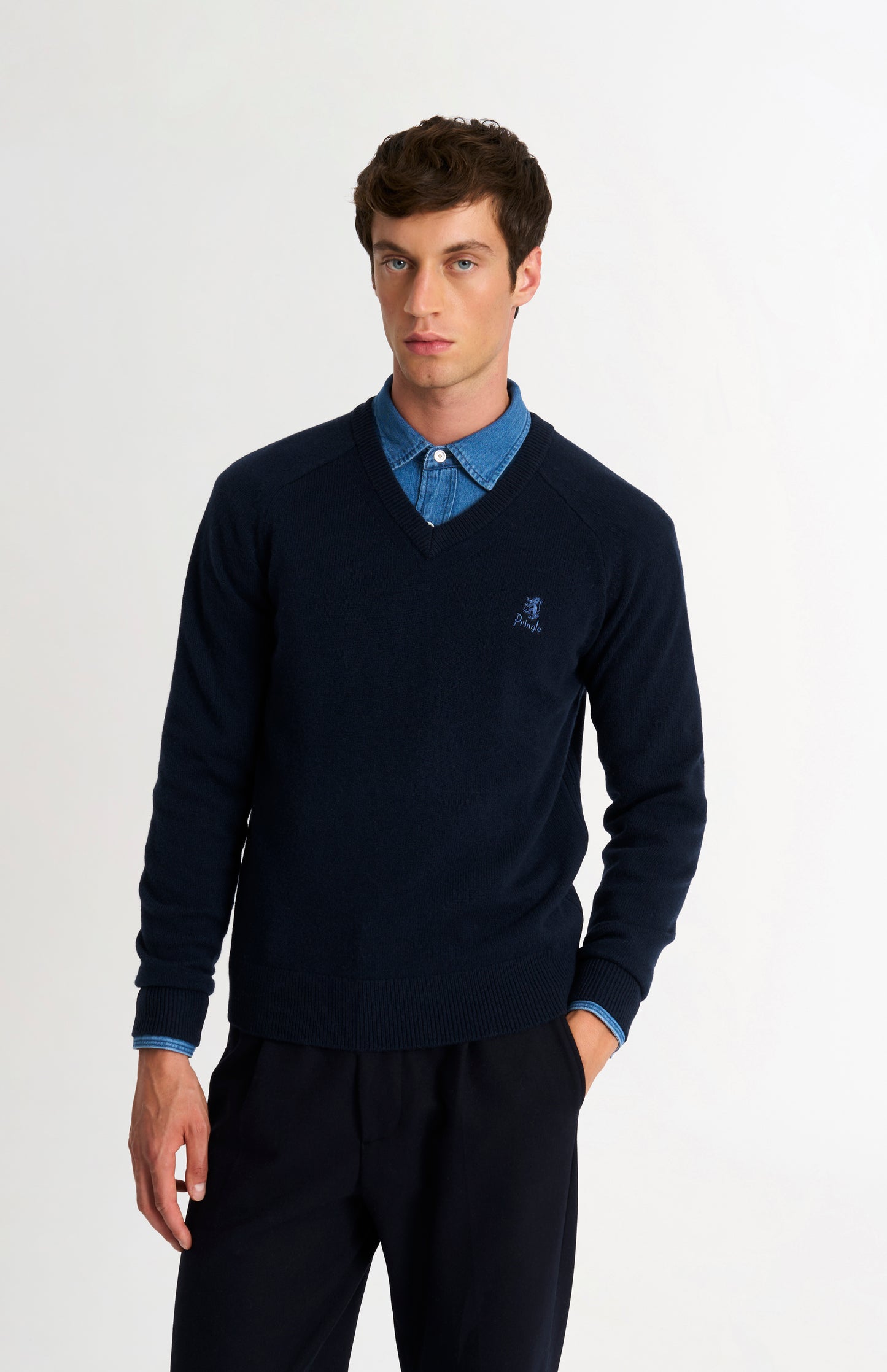Pringle of Scotland Men’s Lambswool V Neck Jumper In Navy Blue on model