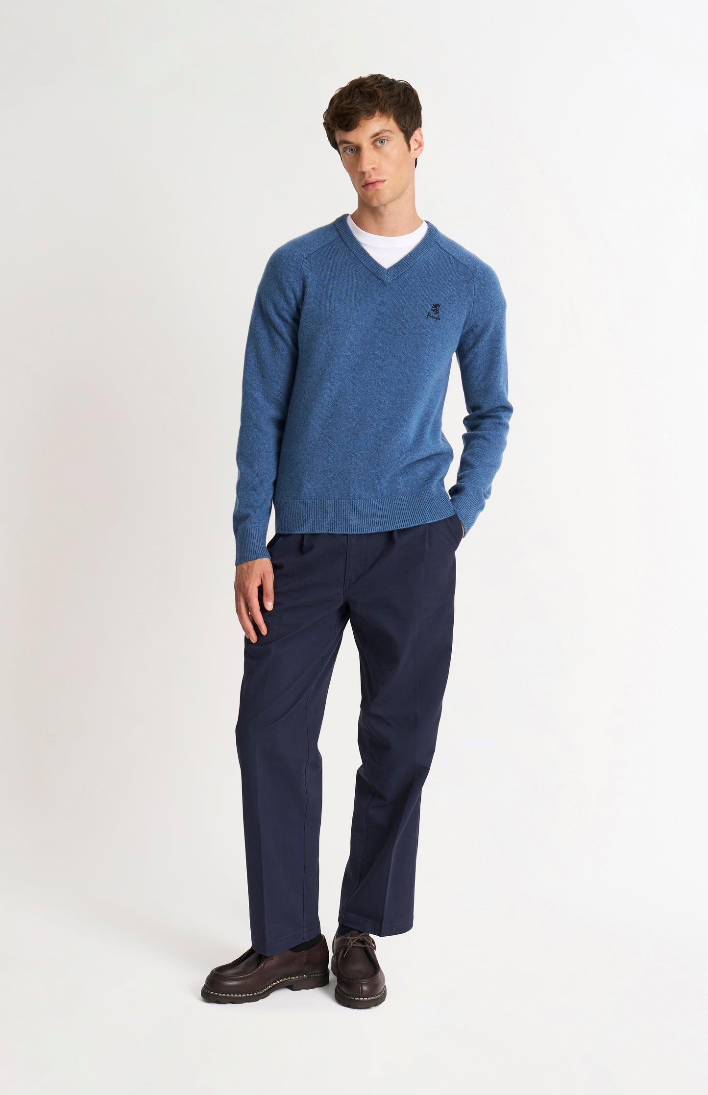 Pringle of Scotland Men’s Lambswool V Neck Jumper In Bering Sea Blue on standing model