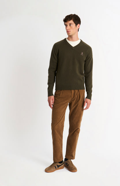 Pringle of Scotland Men’s Lambswool V Neck Jumper In Dark Olive on standing model