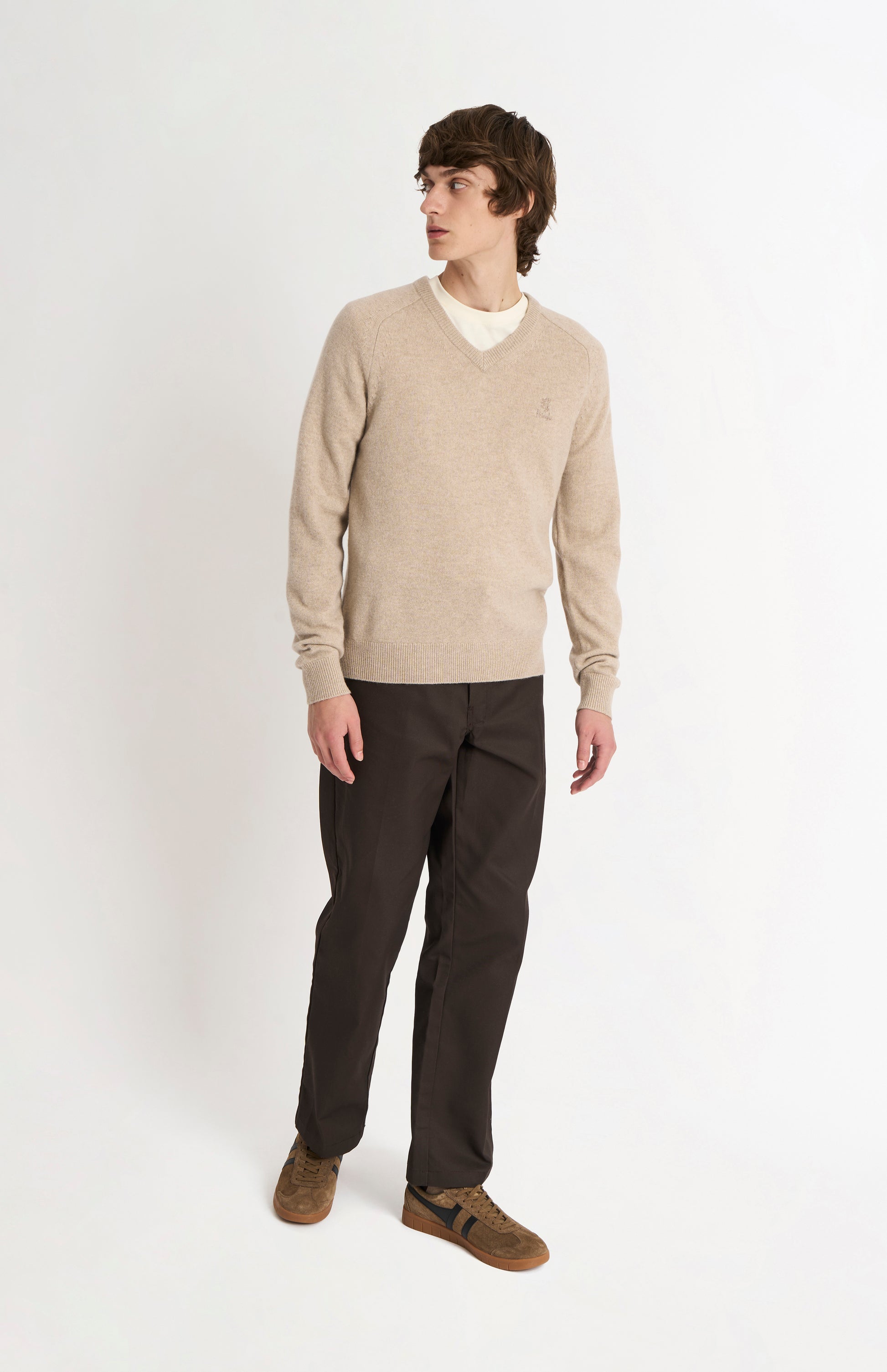 Pringle of Scotland Men’s Lambswool V Neck Jumper In Oatmeal on standing model