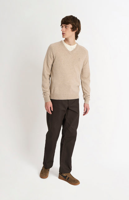 Pringle of Scotland Men’s Lambswool V Neck Jumper In Oatmeal on standing model