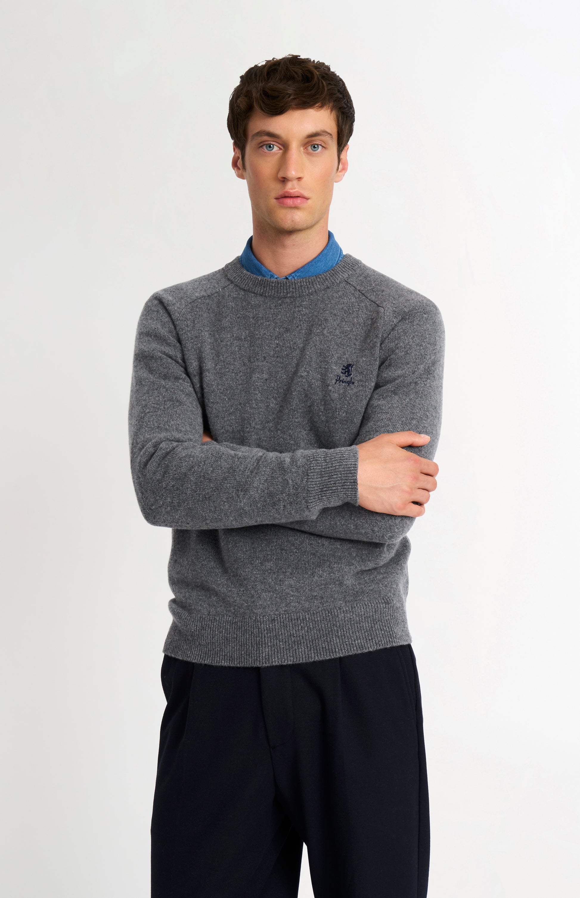 Pringle of Scotland Men’s Lambswool Crew Neck Jumper In Grey Melange on model with crossed arms