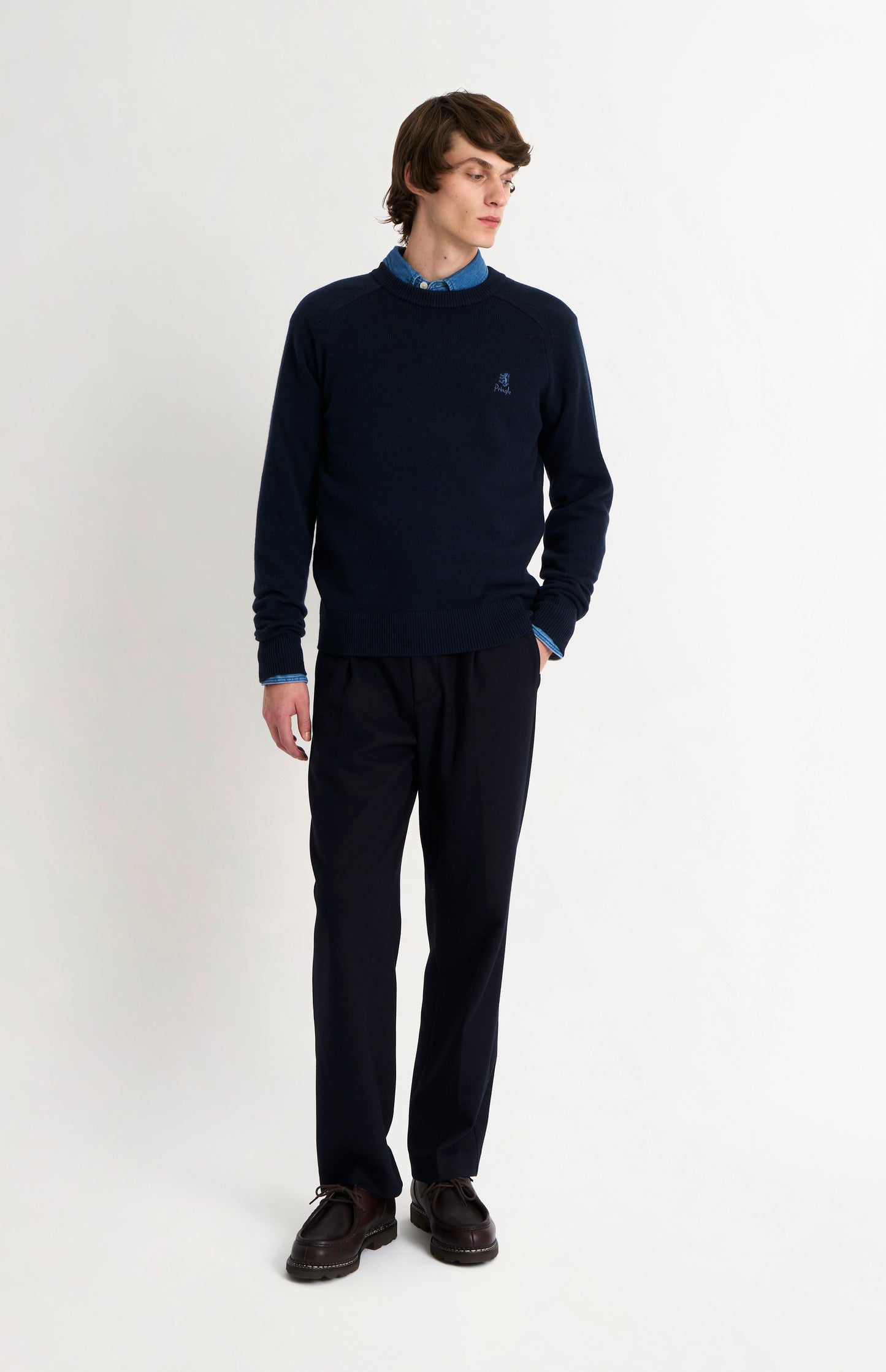 Pringle of Scotland Men’s Lambswool Crew Neck Jumper In Navy Blue on standing model